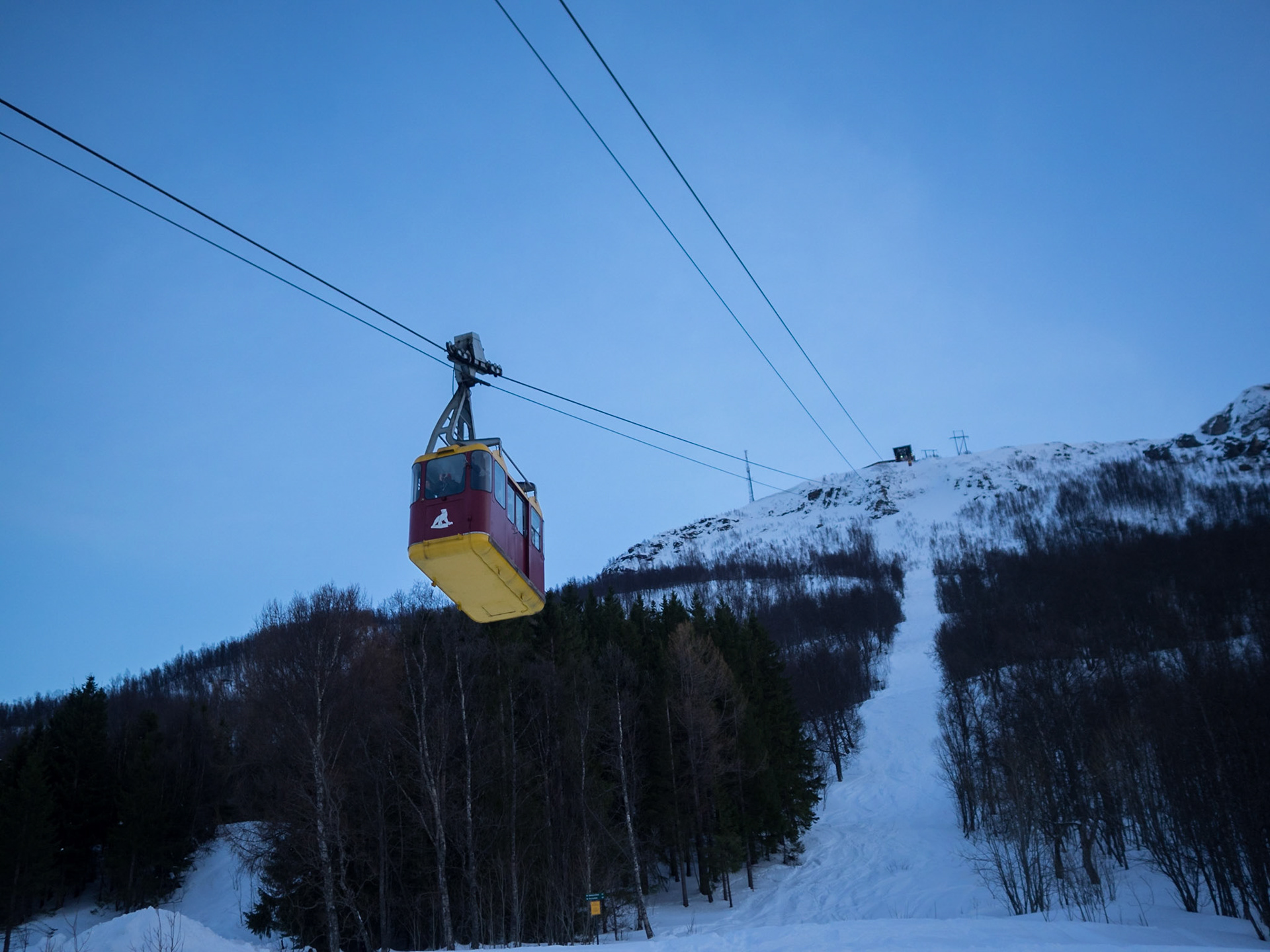 Cable car cabin over the Arctic Circle snow covered landscape of Tromso