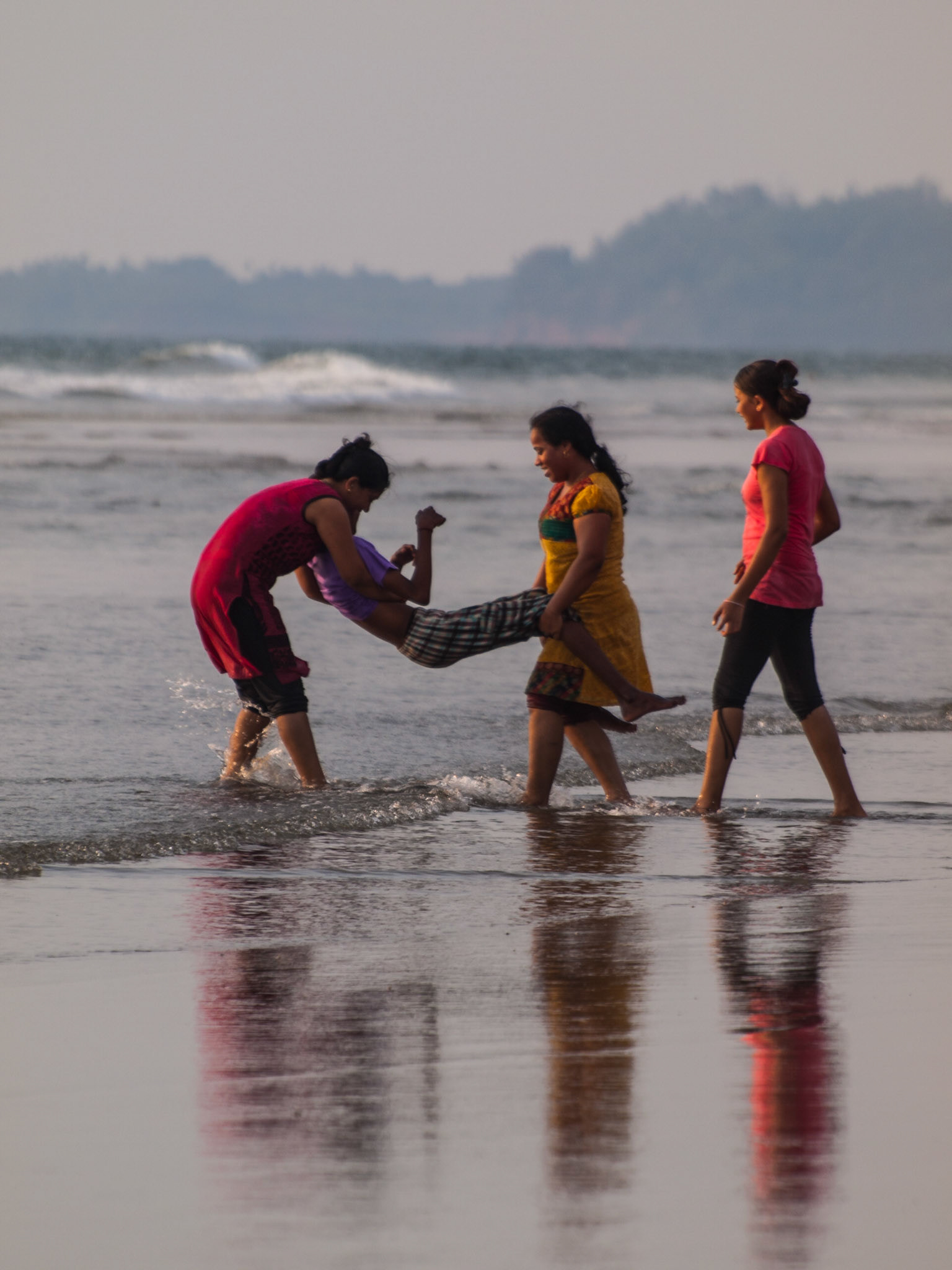 Indian girls playing in the sea of Mandrem beach