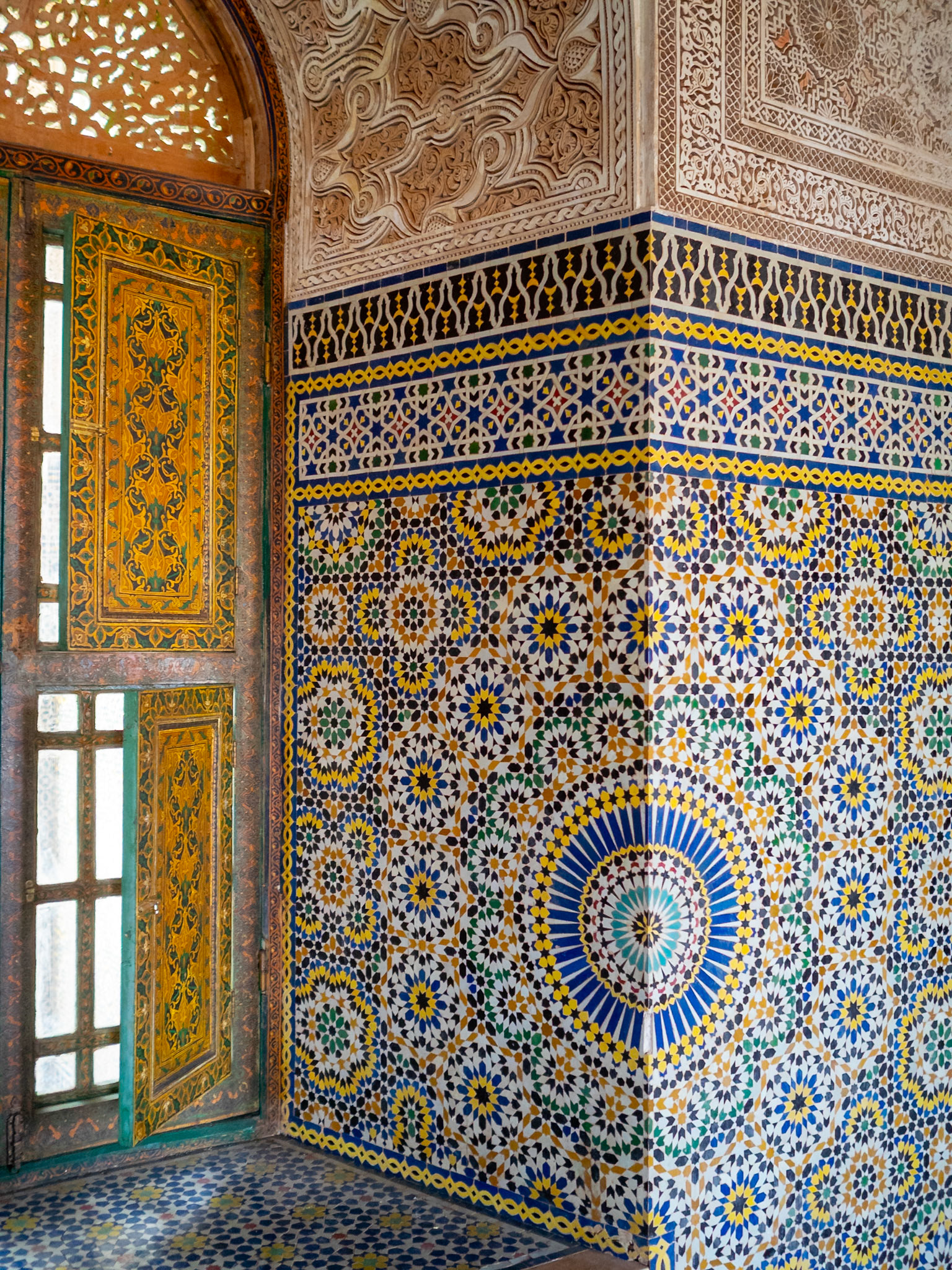 Zellij mosaic geometric pattern and wooden window shutter, Telouet Kasbah, Morcocco