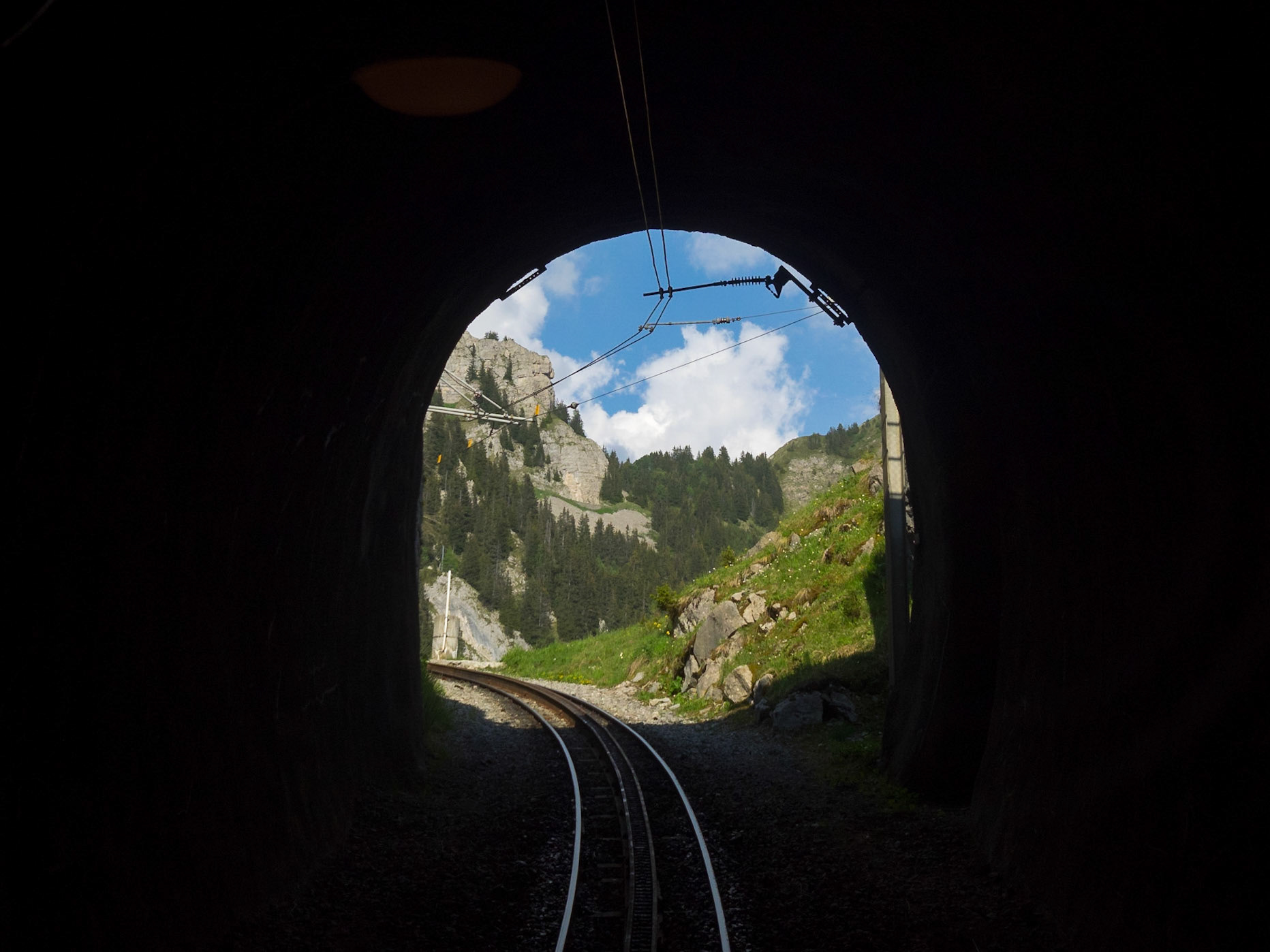 Schynige Platte Railway tunnel with the mountains in the end