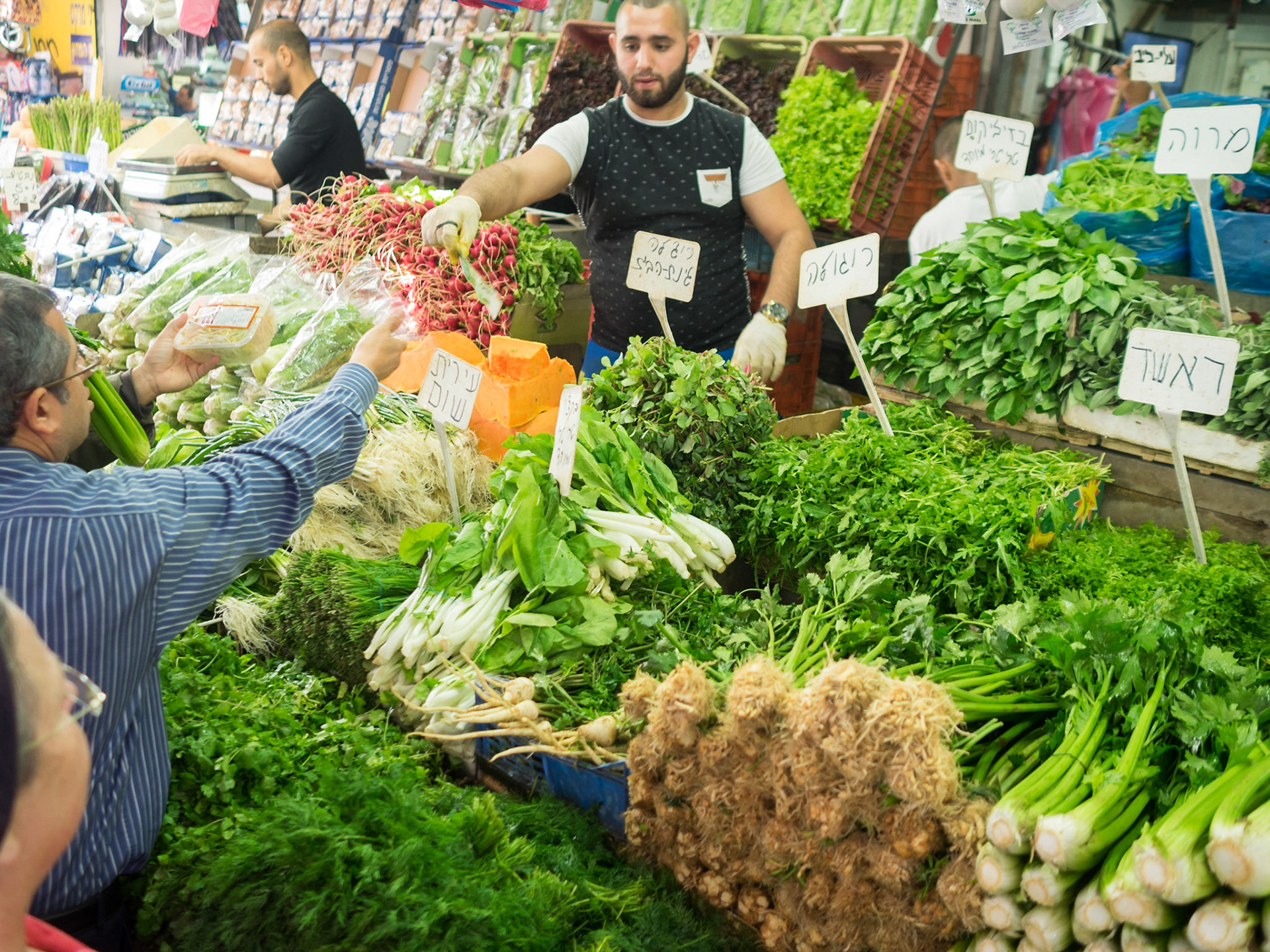Selling vegetables in Tel Aviv market