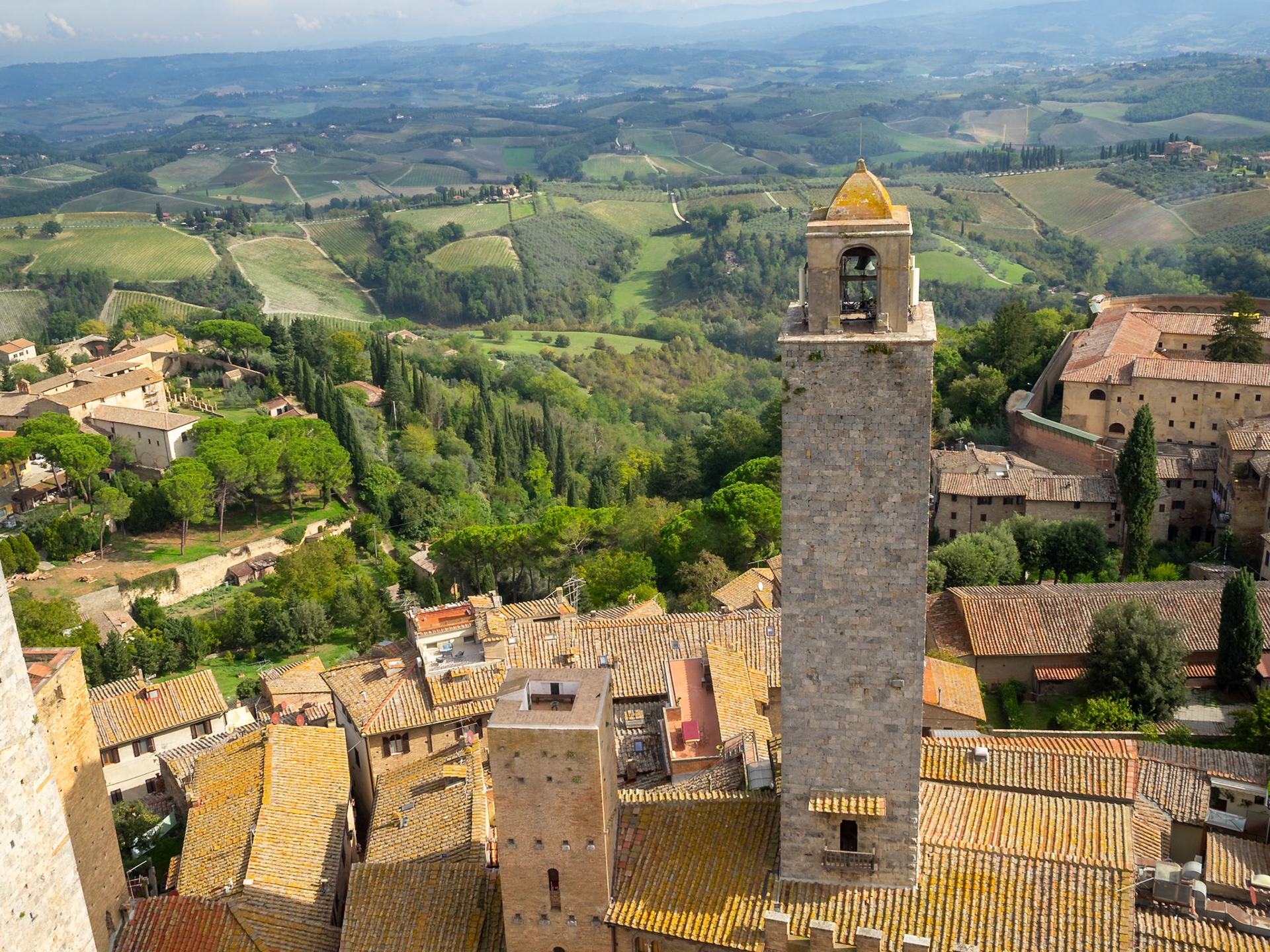 San Gimignano roof tops and medieval towers above the Tuscan ladnscape