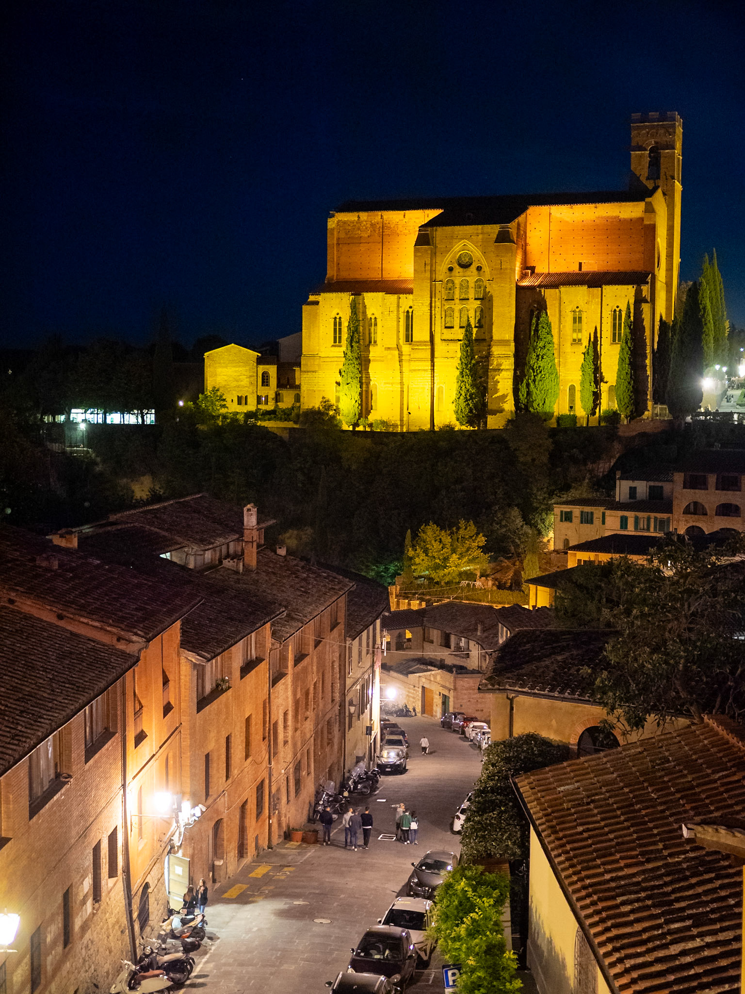 San Domenico Basilica at night above Siena streets