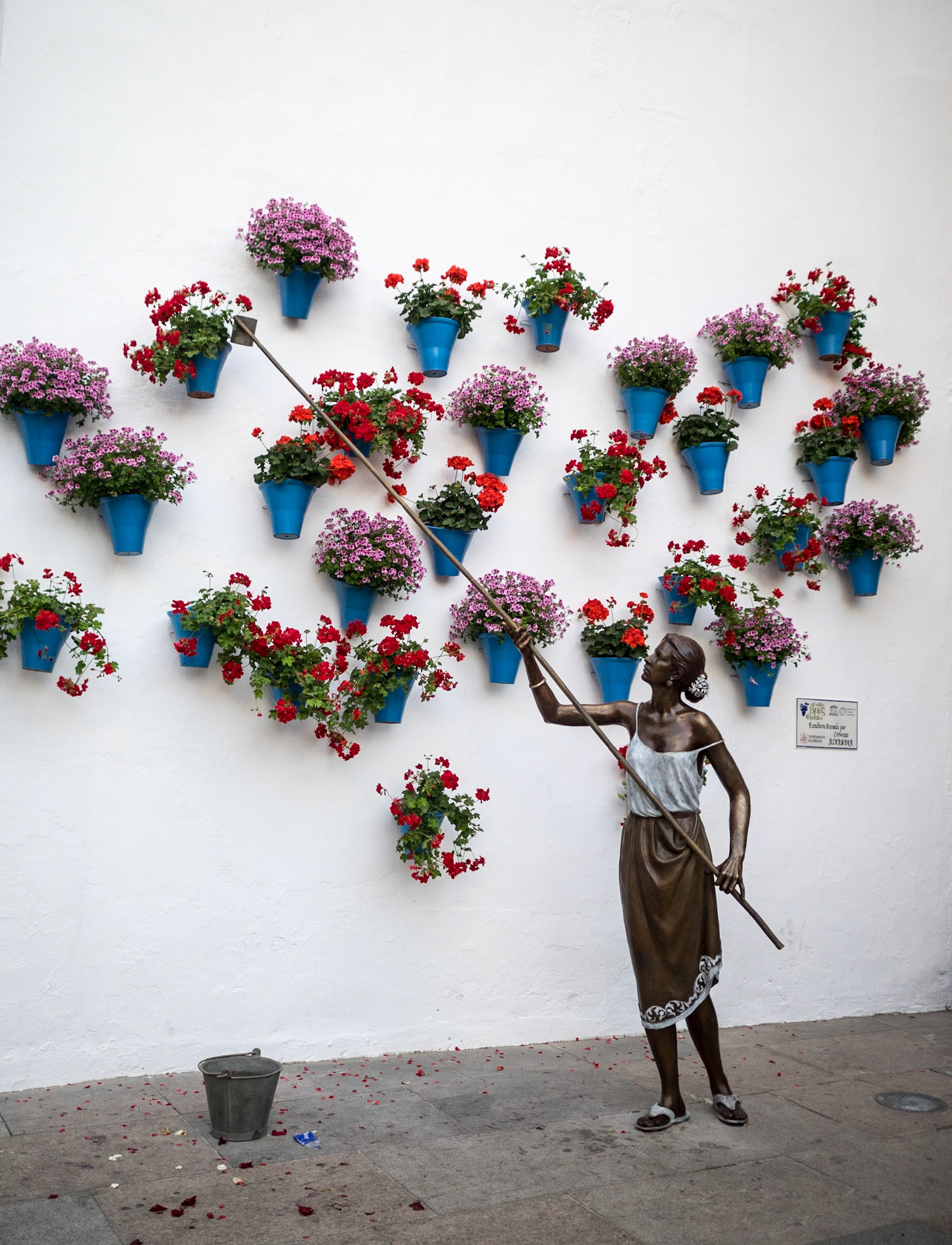 Street sculpture of woman watering plants, Cordoba