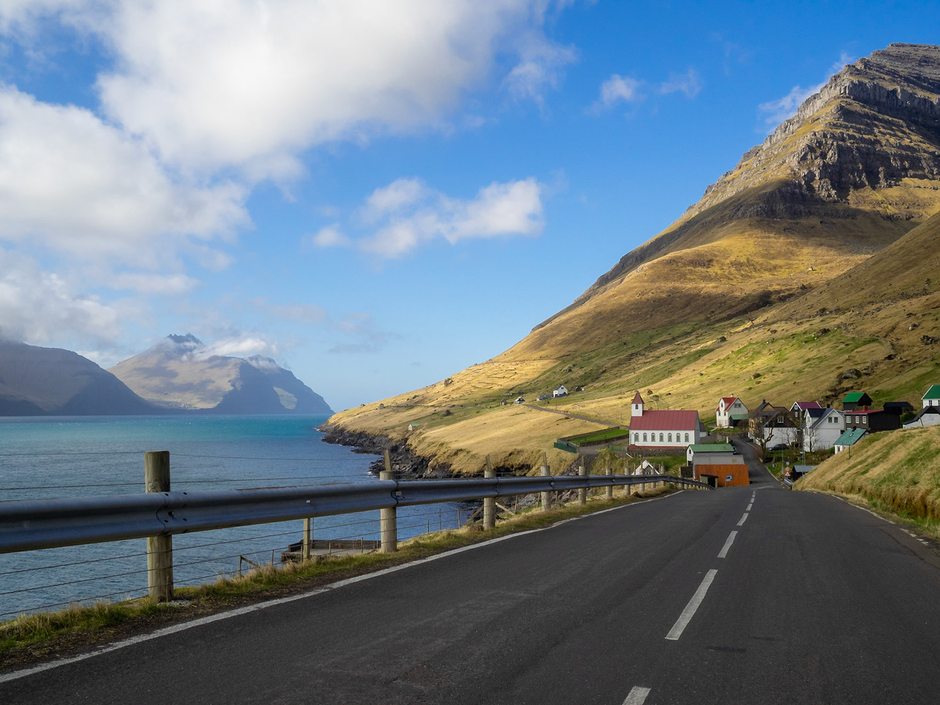 Road to Kunoyar hamlet, below Kúvingafjall mountain, with Kalsoyarfjørður and Kalsoy island on the left
