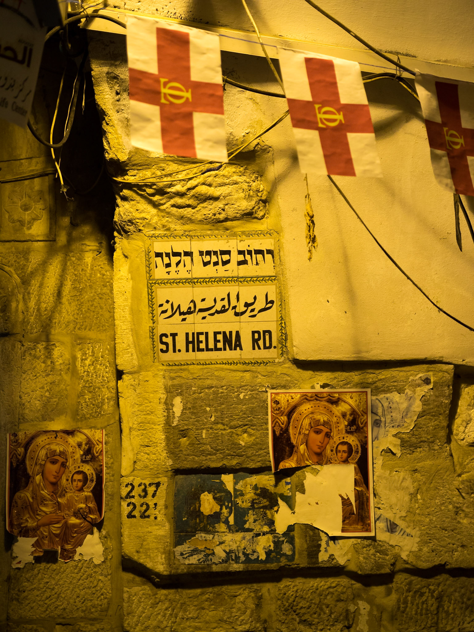 Christian posters and flags by the sign of St. Helena street in Old Jerusalem