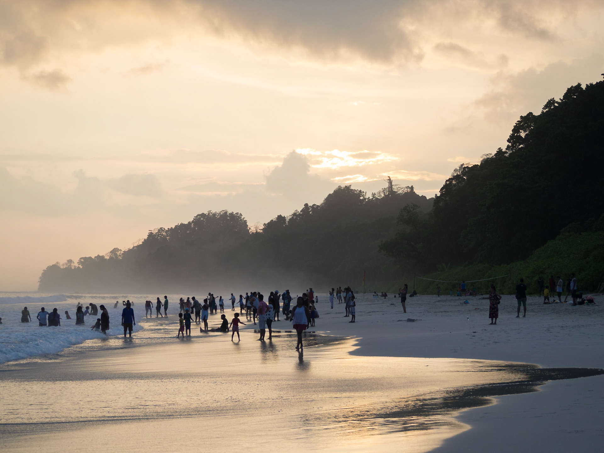 People silhouettes at sunset in Radhanagar beach, Havelock