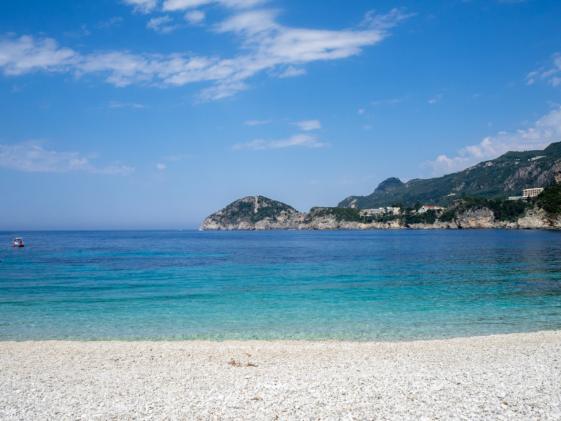 Turquoise sea and white pebbled beach of Paliokastritsa