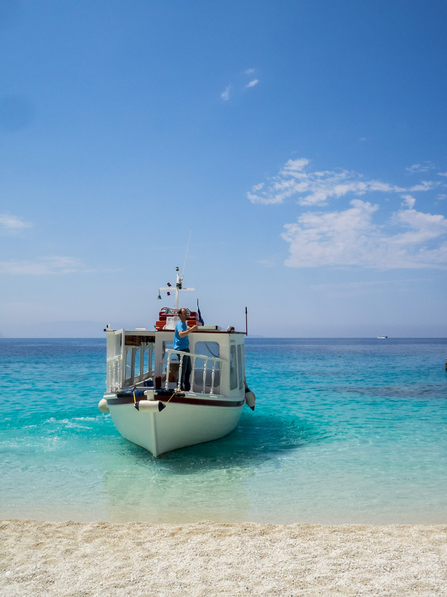 Taxi boat in the turquoise sea at Agyofili beach