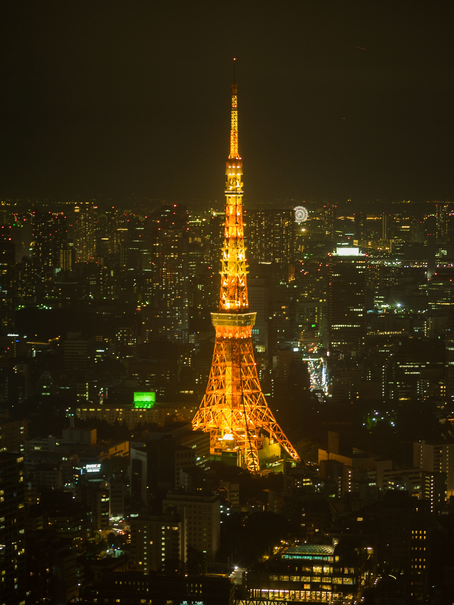 Tokyo Tower between the city landscape in the night lights