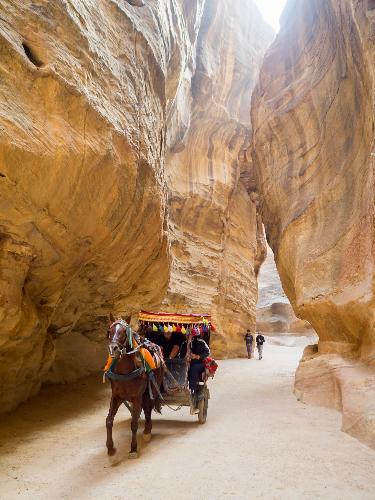 Tourists ridding a chariot in Petra Siq