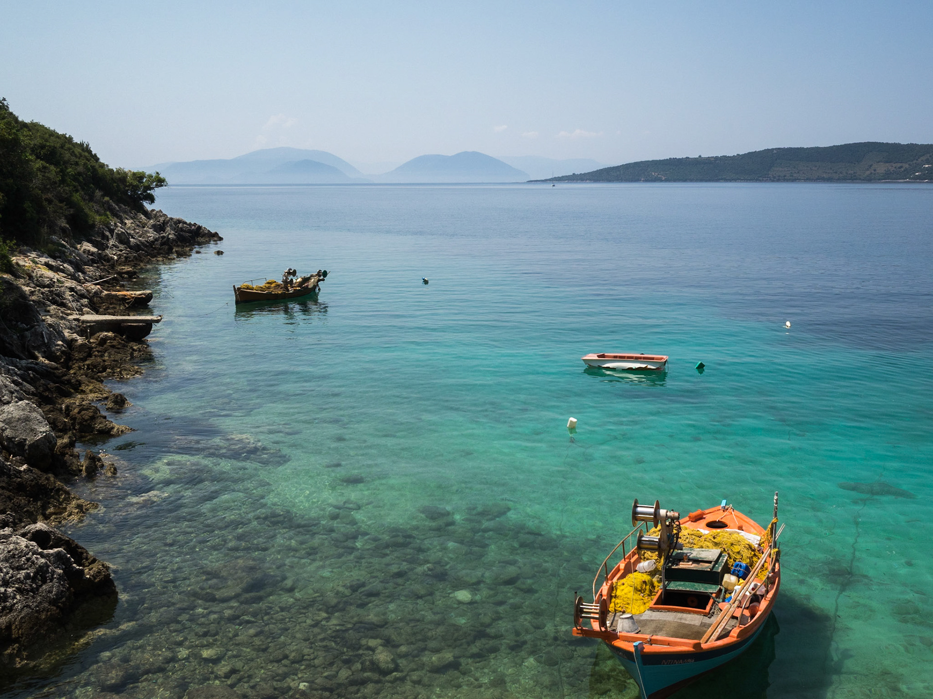 boats on the transparent waters of Afteli beach