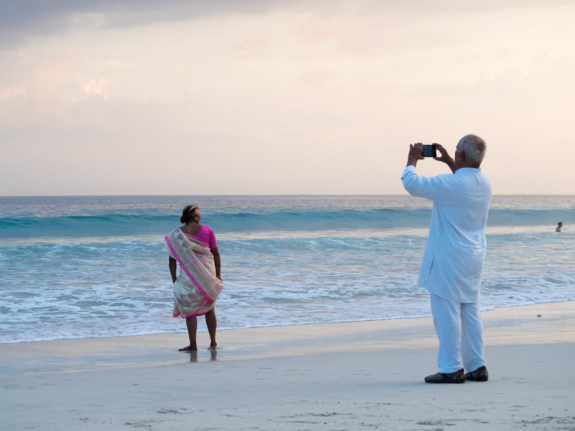 Old Indian couple taking a picture in Radhanagar beach, Havelock