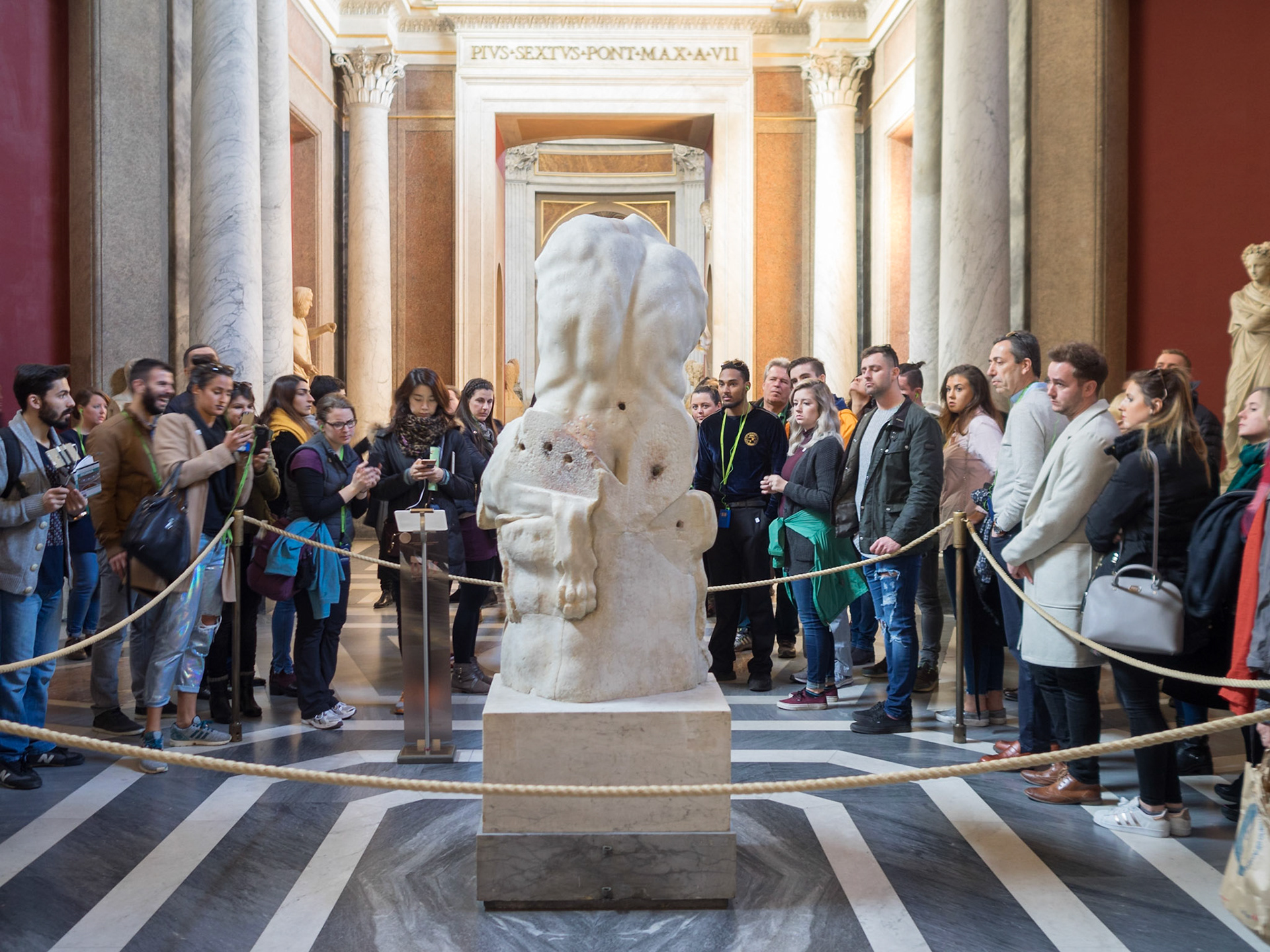 Vatican Museum visitors admiring a statue
