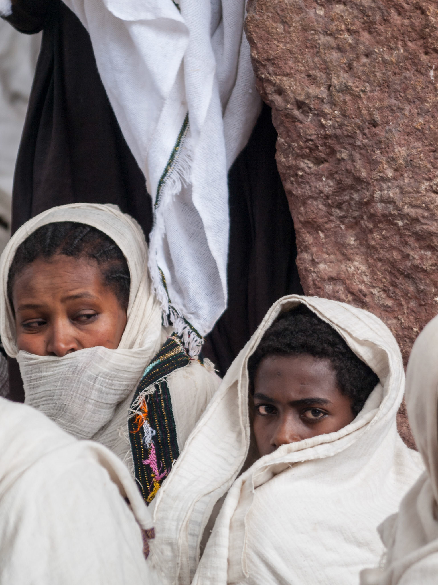 Pilgrims sitting outside church praying in Lalibela during Easter