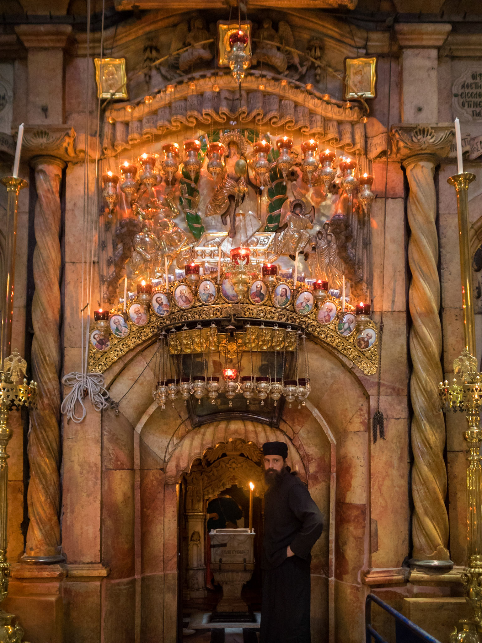 Orthodox priest at the entrance to the Tomb Monument, in the Church of the Holy Sepulcher