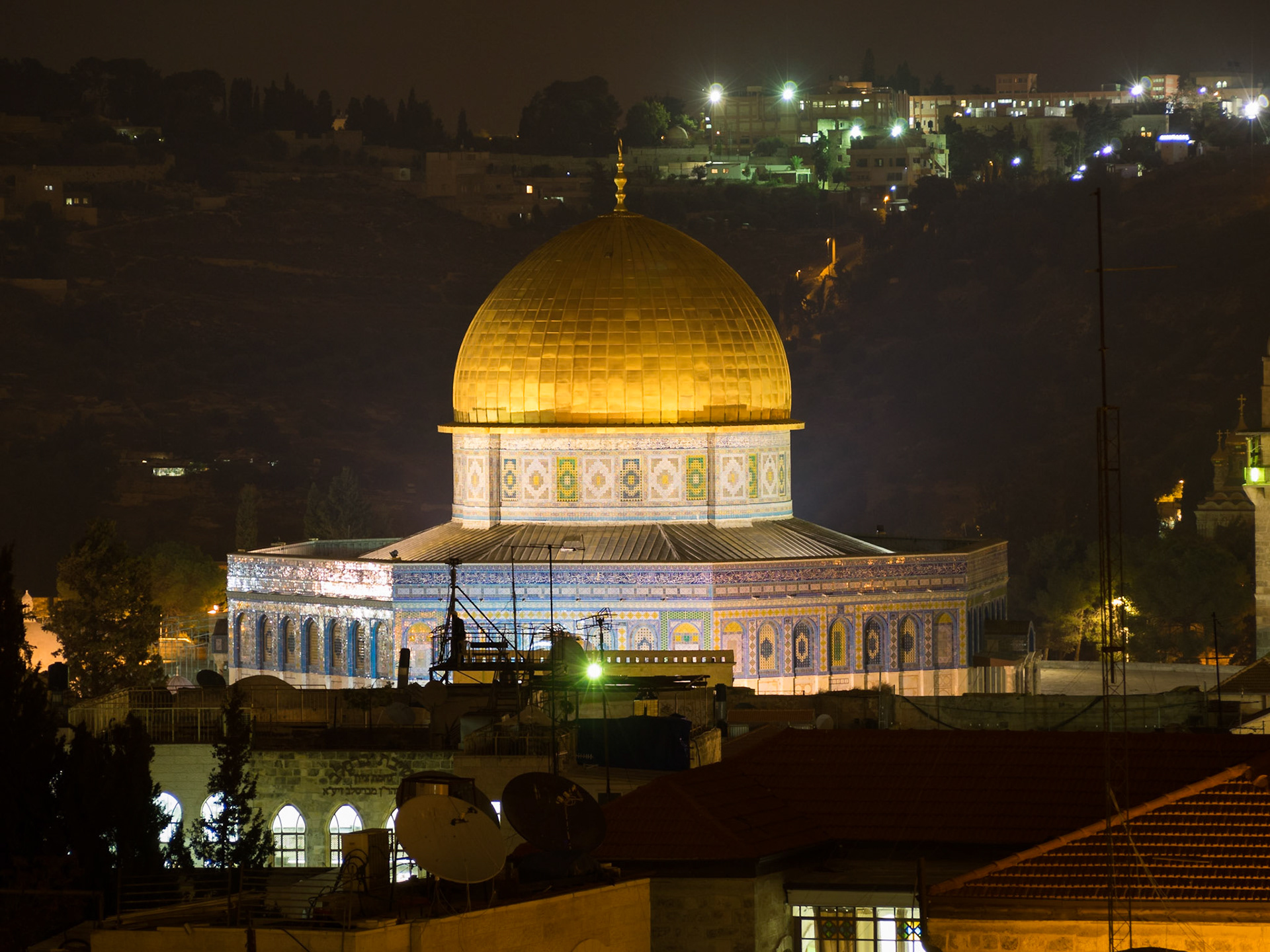 The golden dome of the Dome of the Rock] shines at night over Old Jerusalem