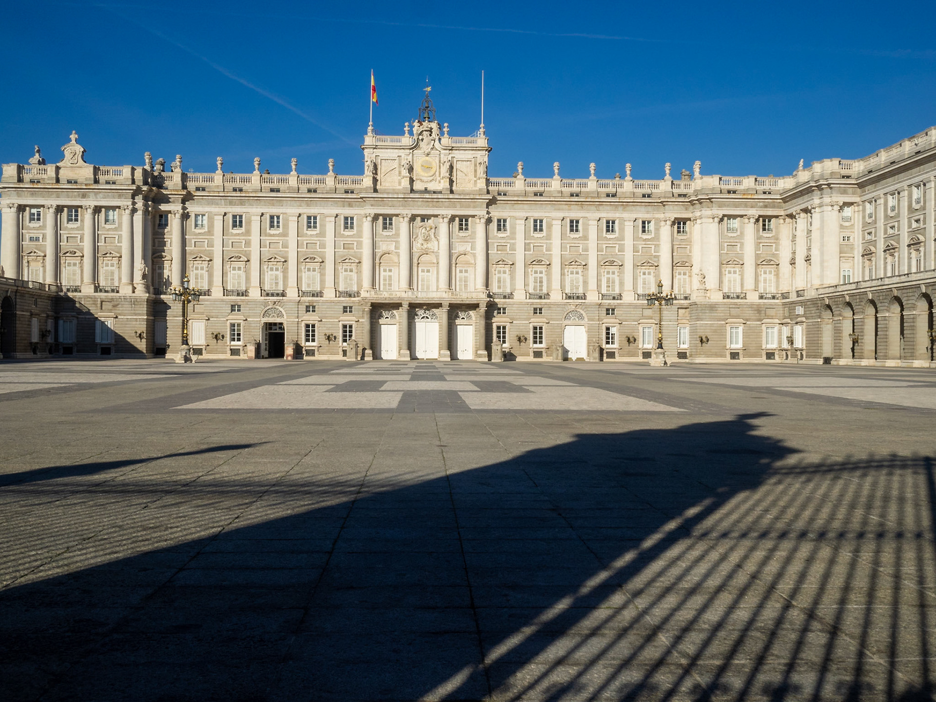 Madrid Royal Palace Plaza de la Armeria with gate shadow projected on the ground