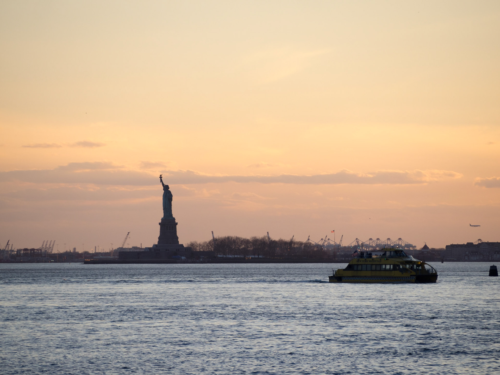 Statue of Liberty silhouette at sunset