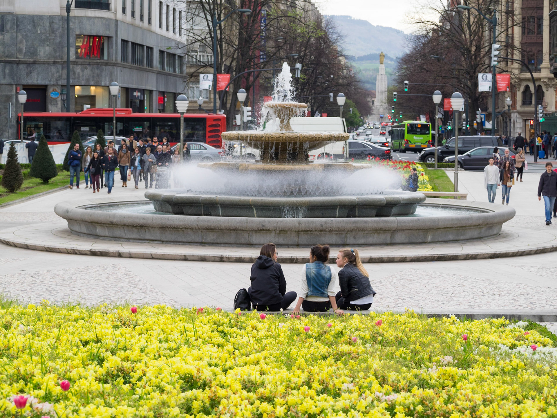 Talking by the flowers in a Bilbao square