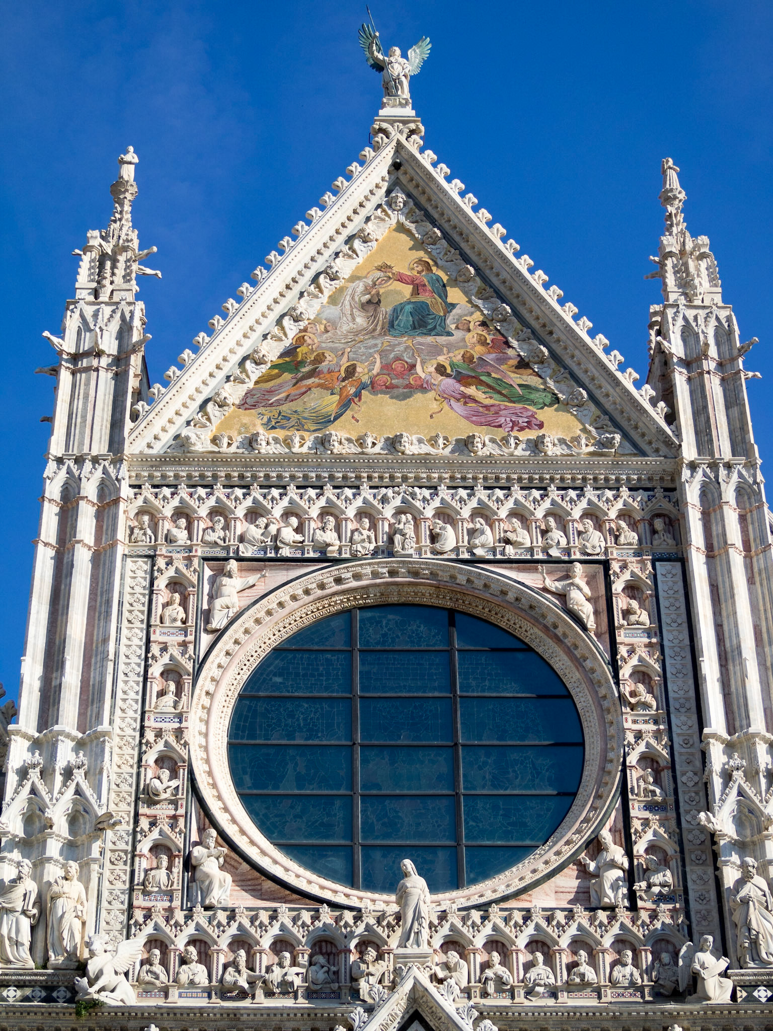 Siena Cathedral facade topped by the Coronation of the Virgin mosaic