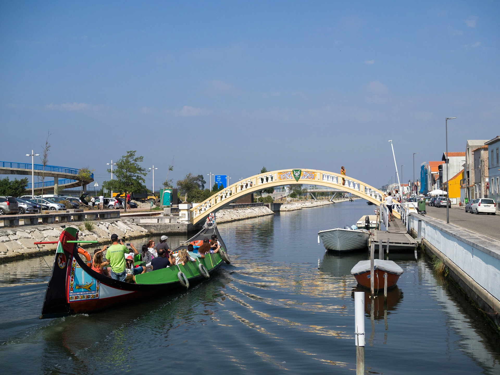 Tourists travelling the Aveiro canals in a typical moliceiro boat