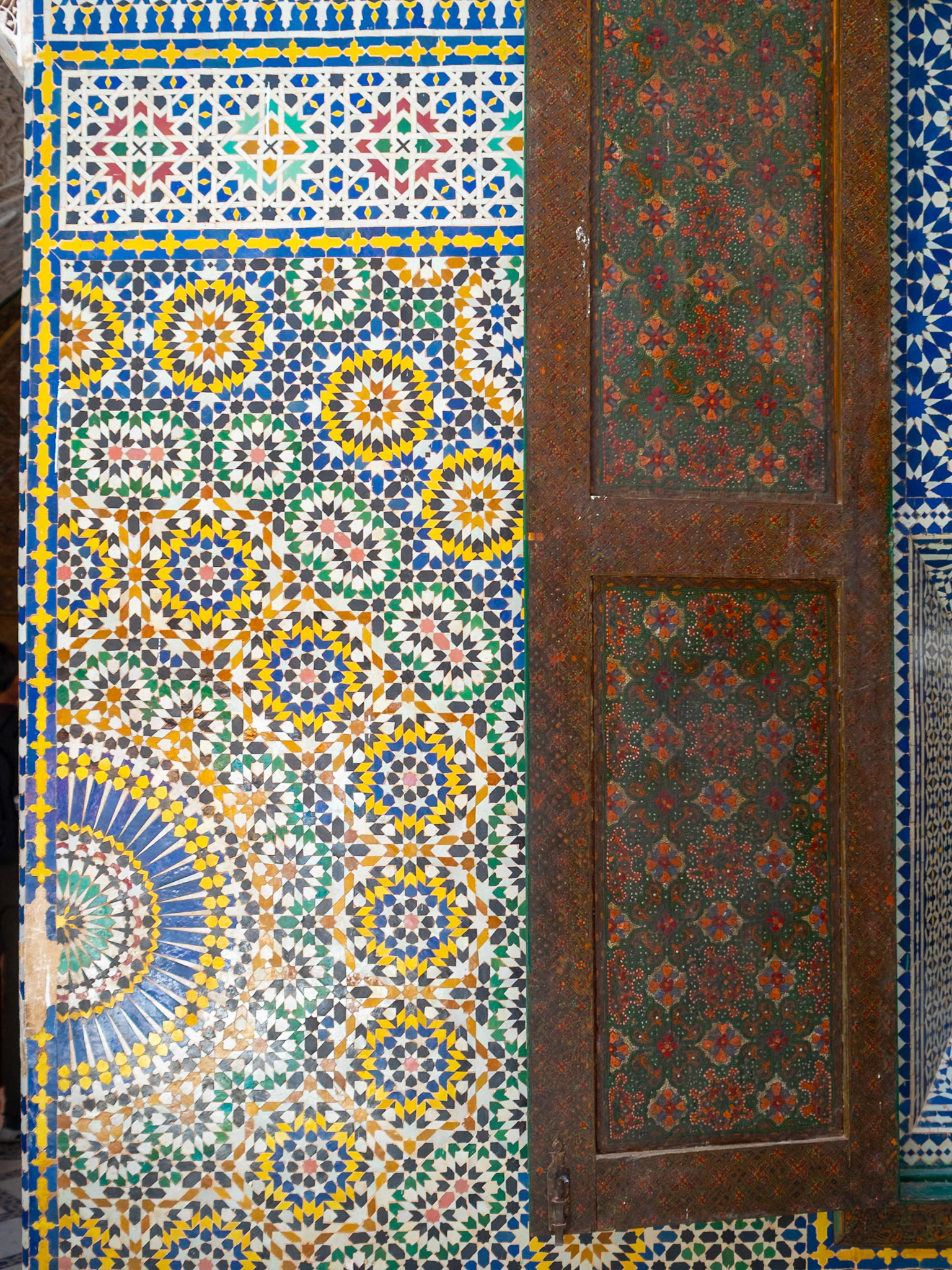 Zellij mosaic geometric pattern and wooden window shutter, Telouet Kasbah, Morcocco