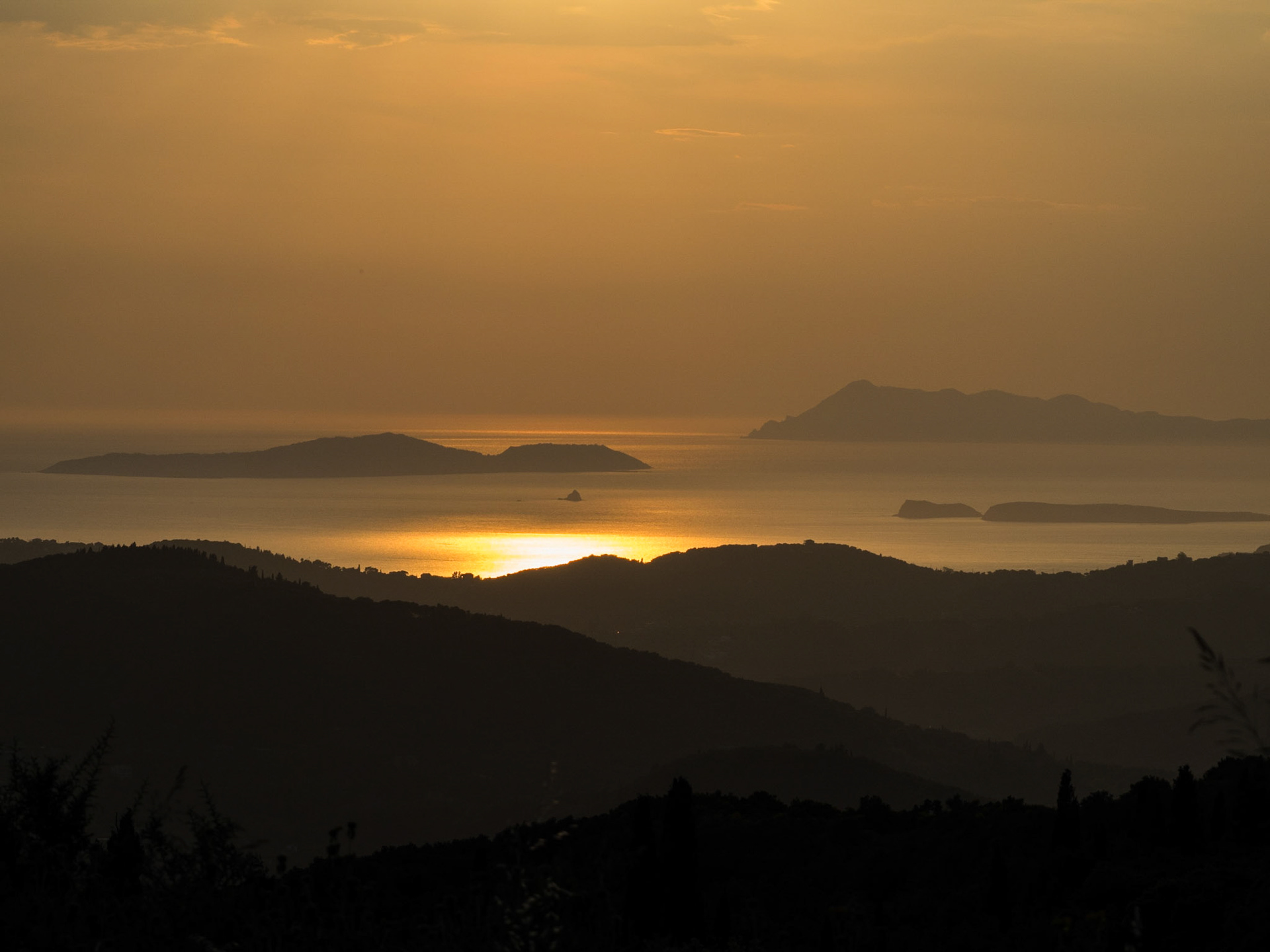 Sunset reflection on the sea between the mountains