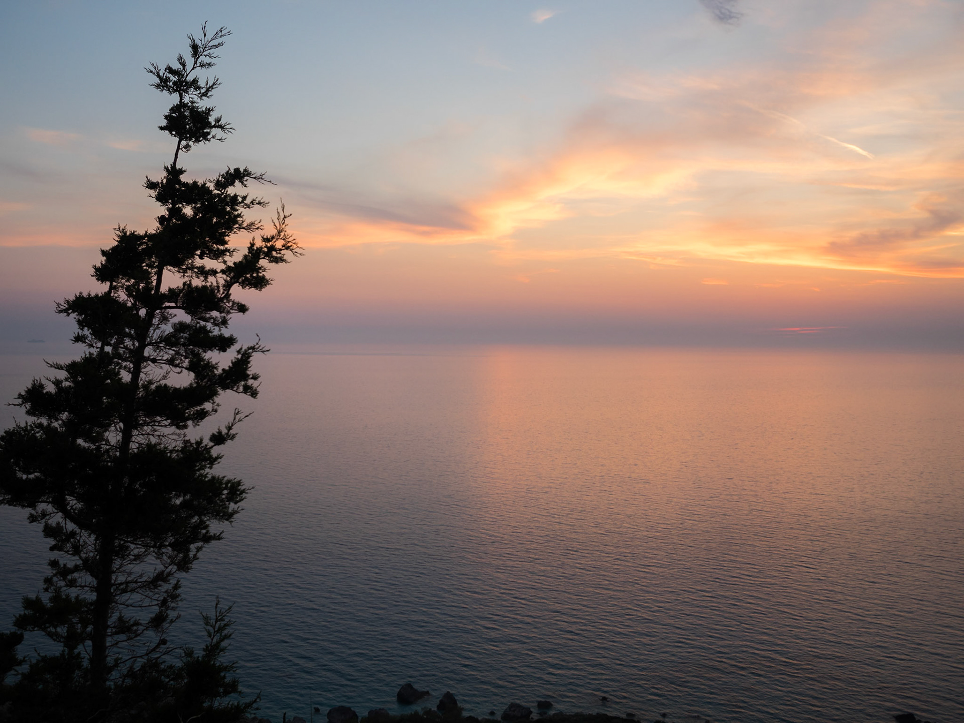 Sunset behind the clouds over the sea