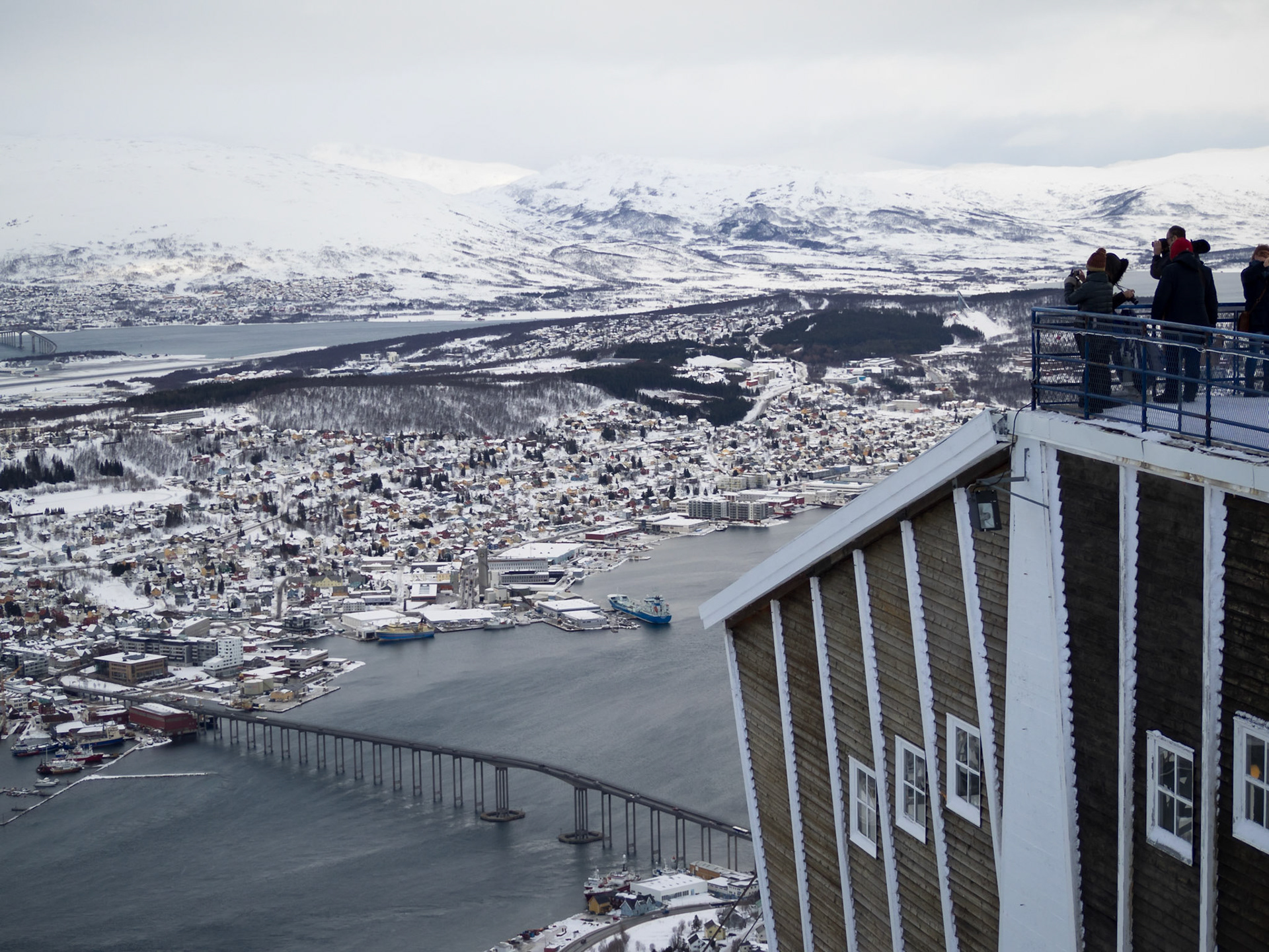 People  on top of Tromso cable car station looking at the city down below