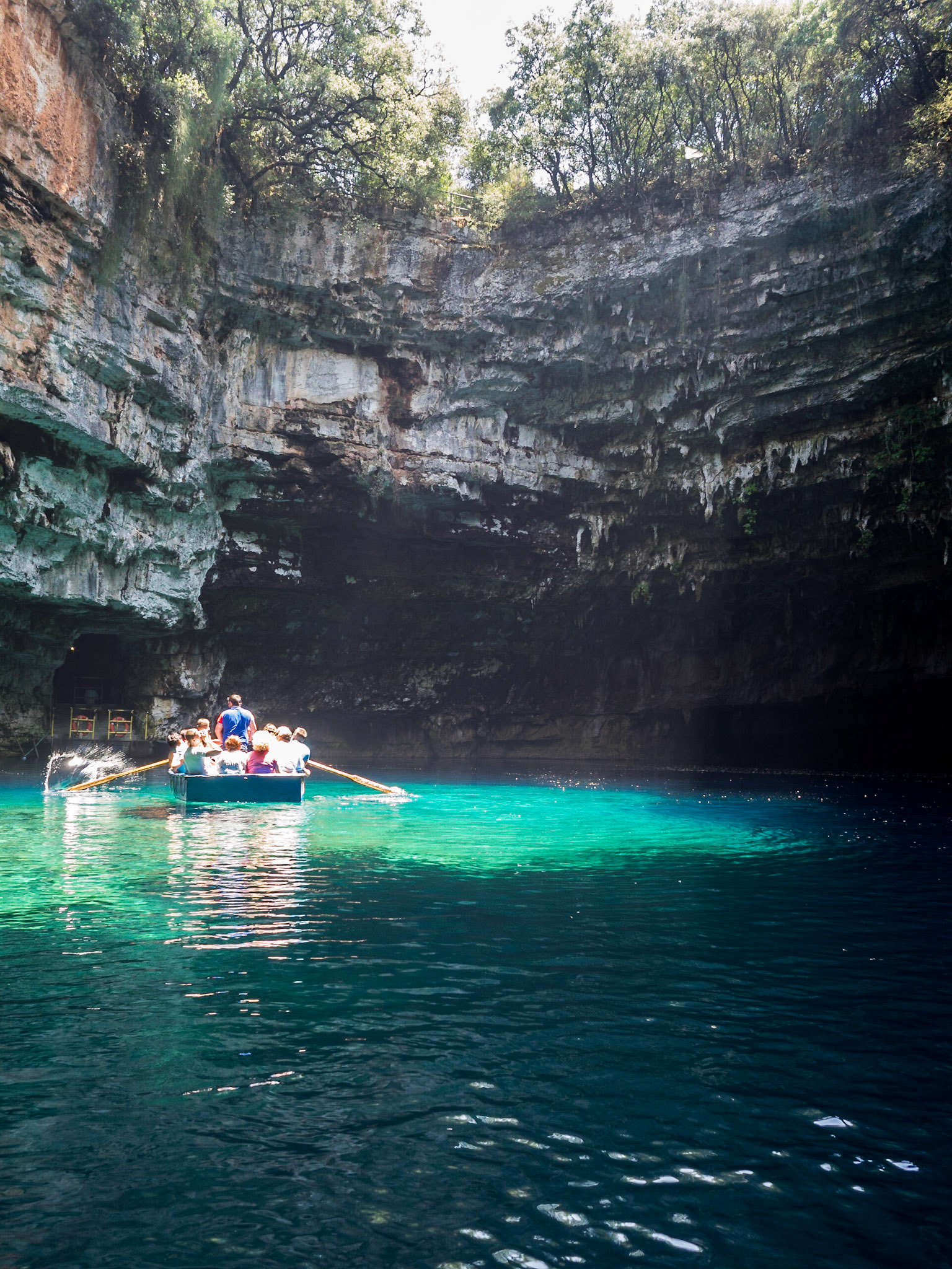 Melissani caves interior where a small boats shows the tourists around when the light enters and illuminates the turquoise water