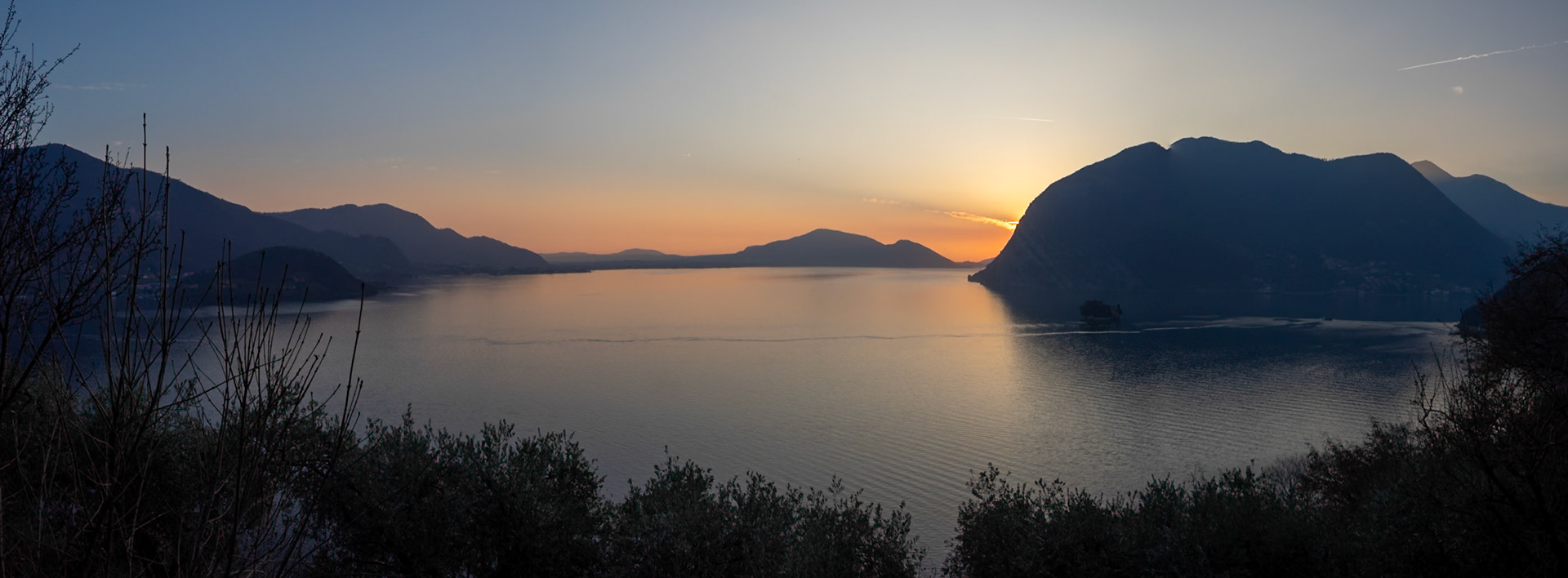 Silhouettes of Montisola and the mountains around Lake Iseo at sunset