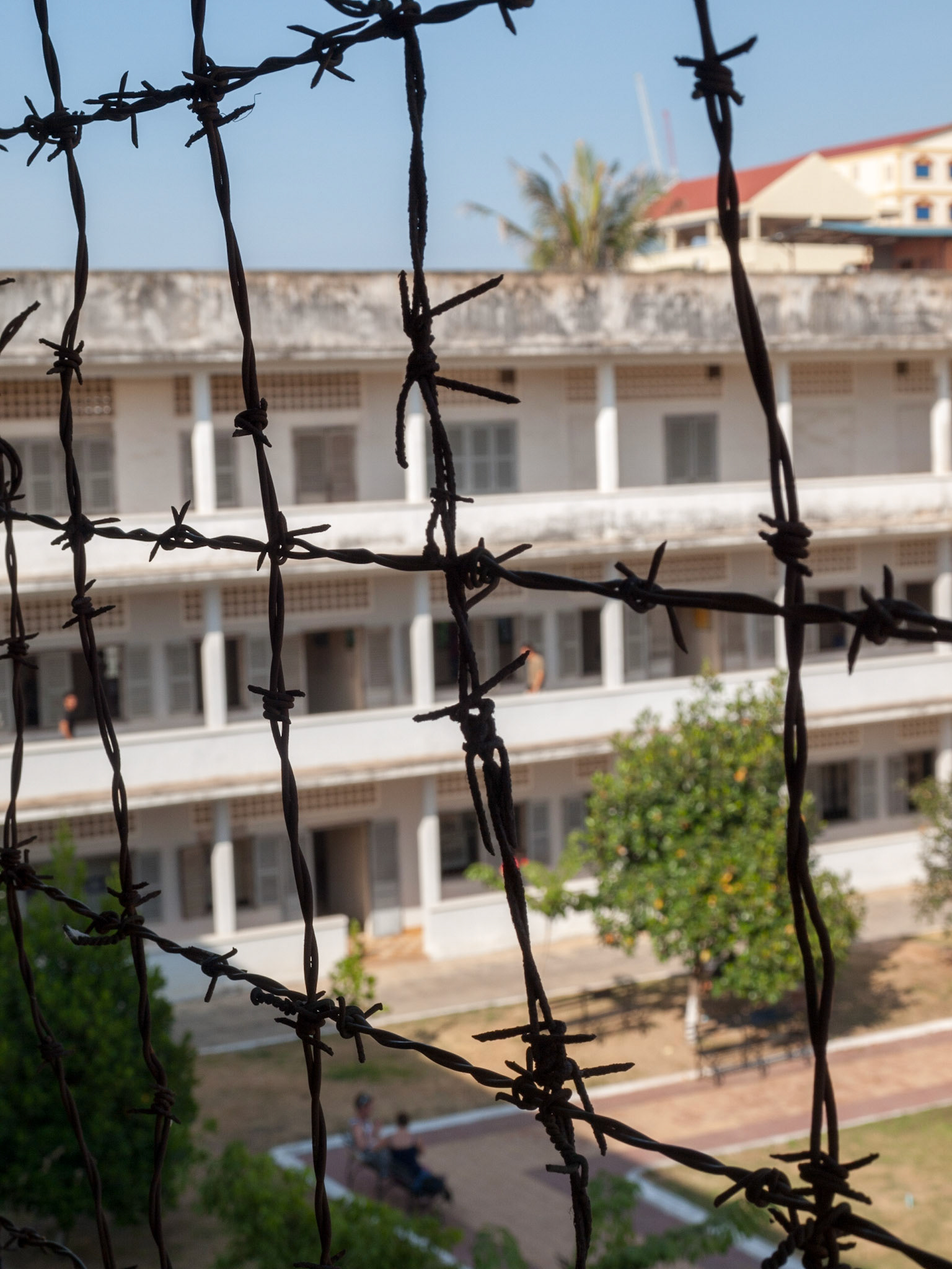 Tuol Sleng prison seen behind its barbed wire