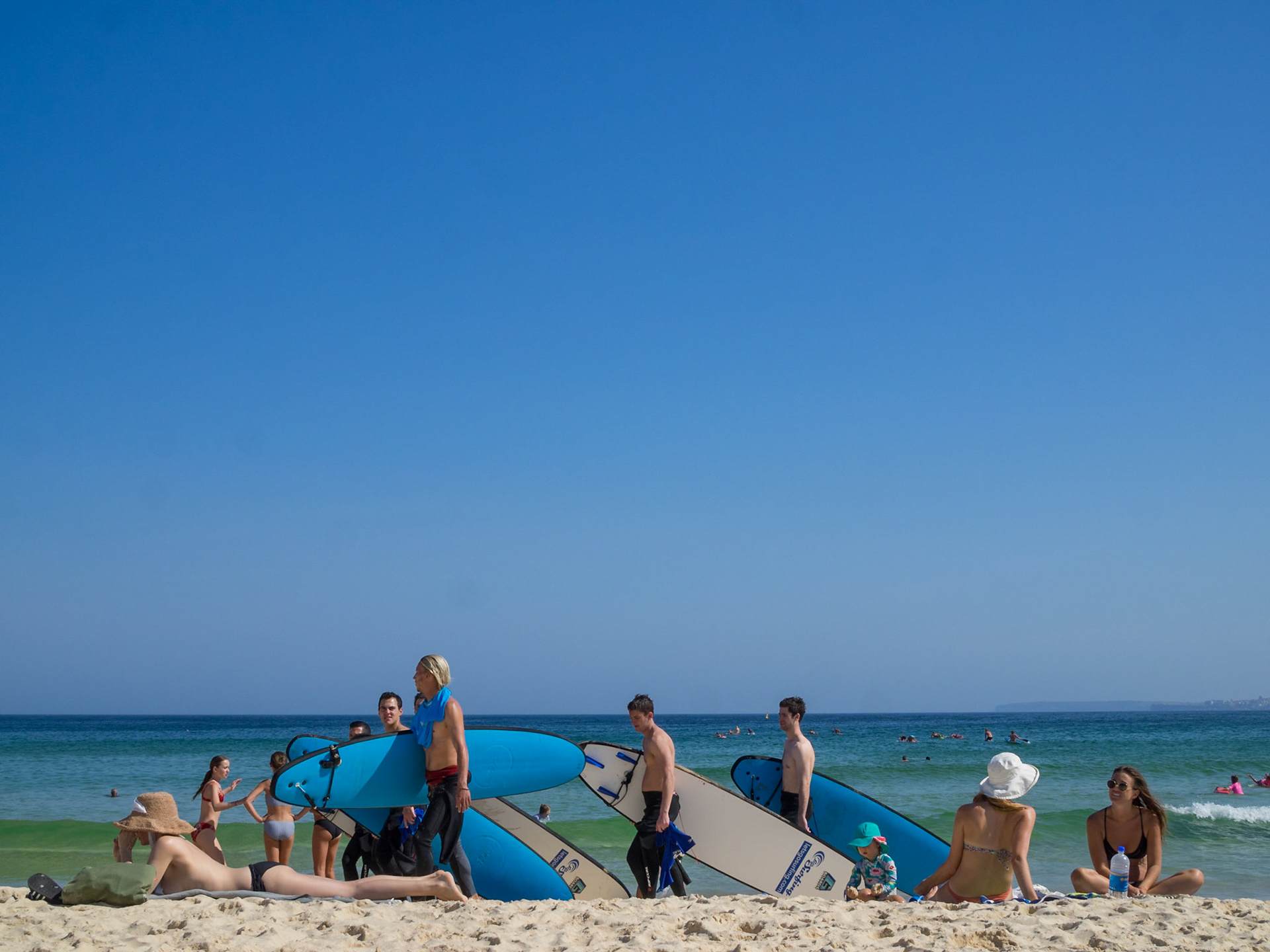 Surfers and sun goers in Bondi Beach