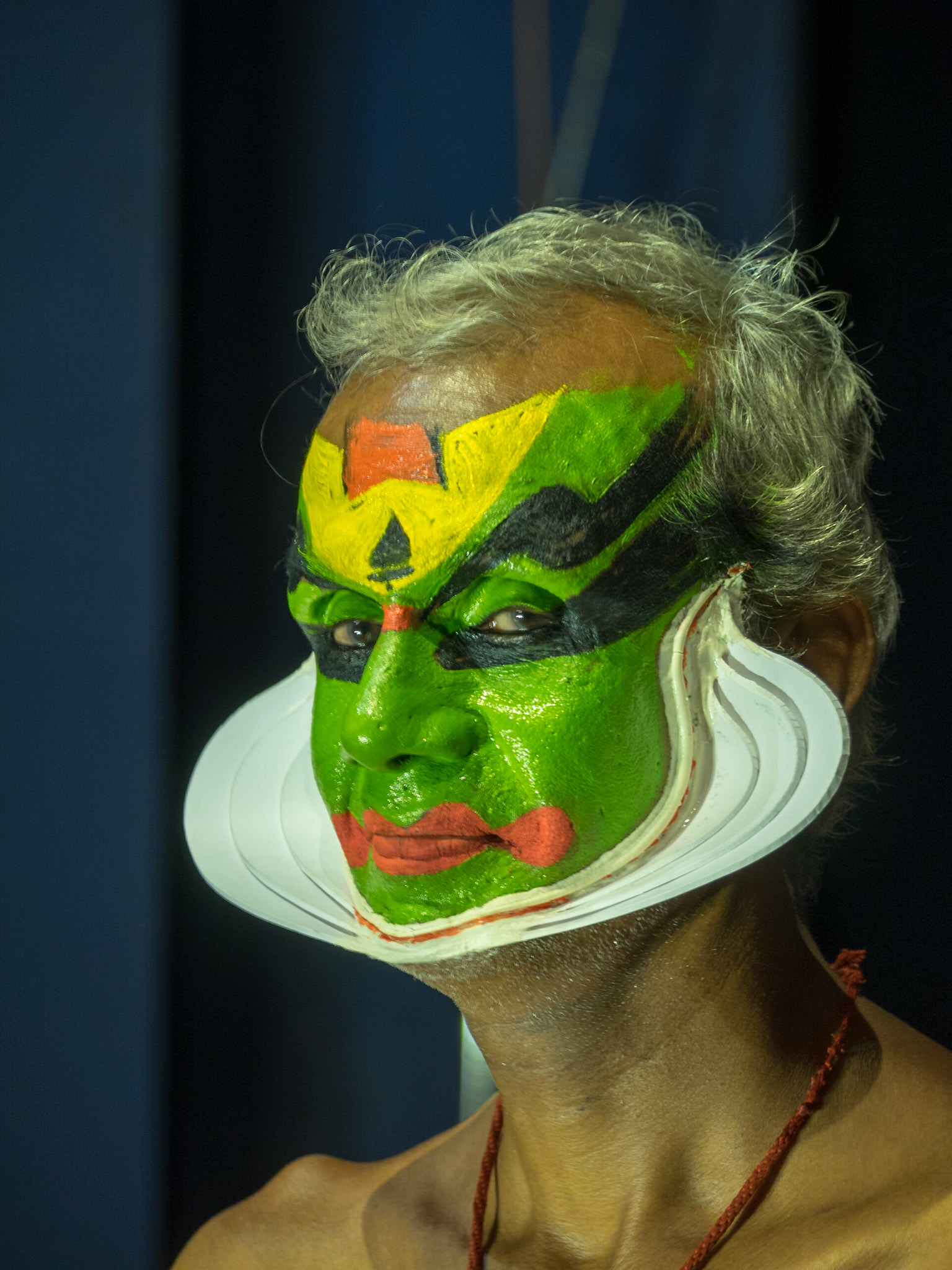 Kathakali performer with painted face before the show