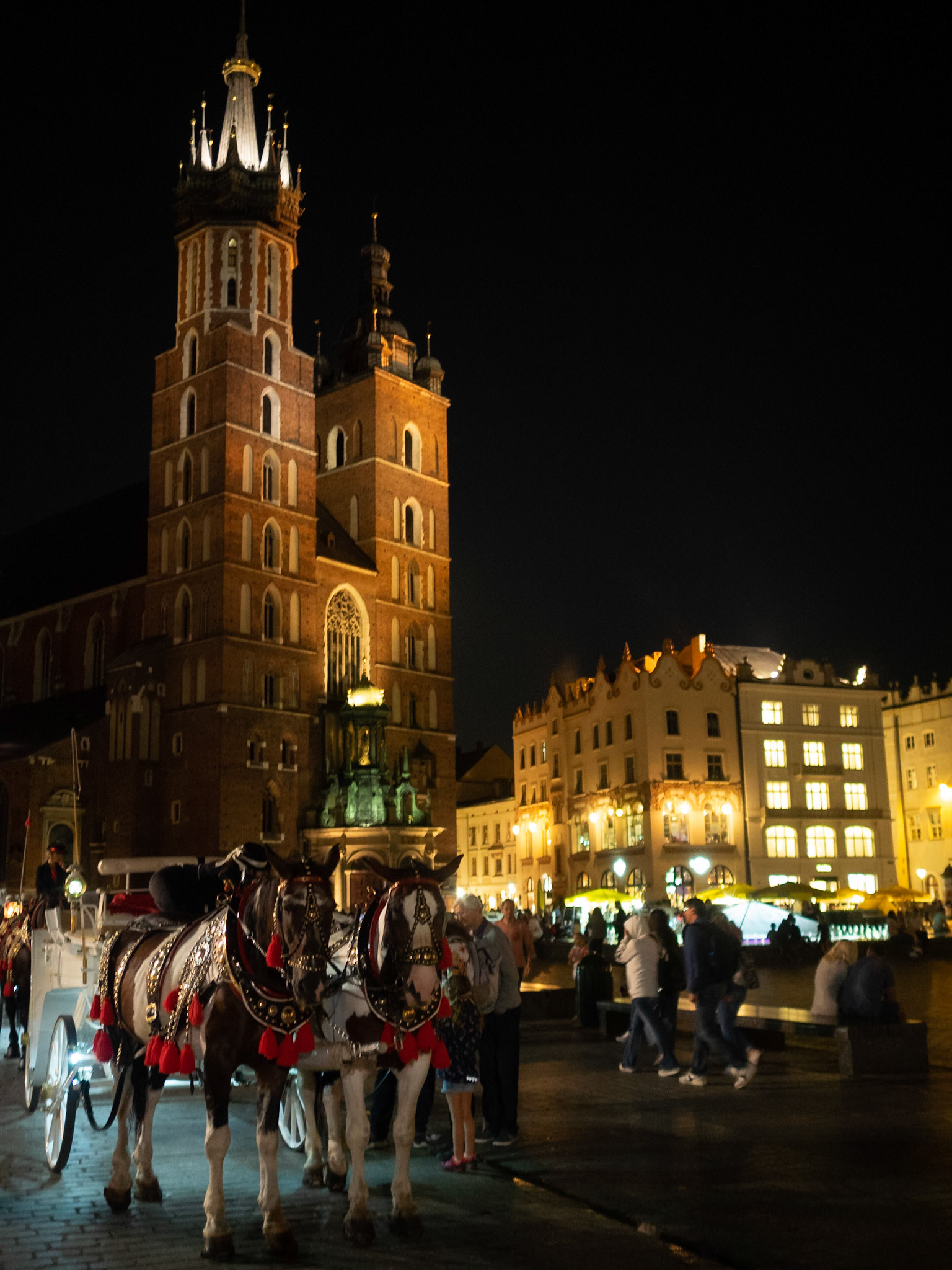 Horse chariot by St. Mary's Basilica at night, Krakow