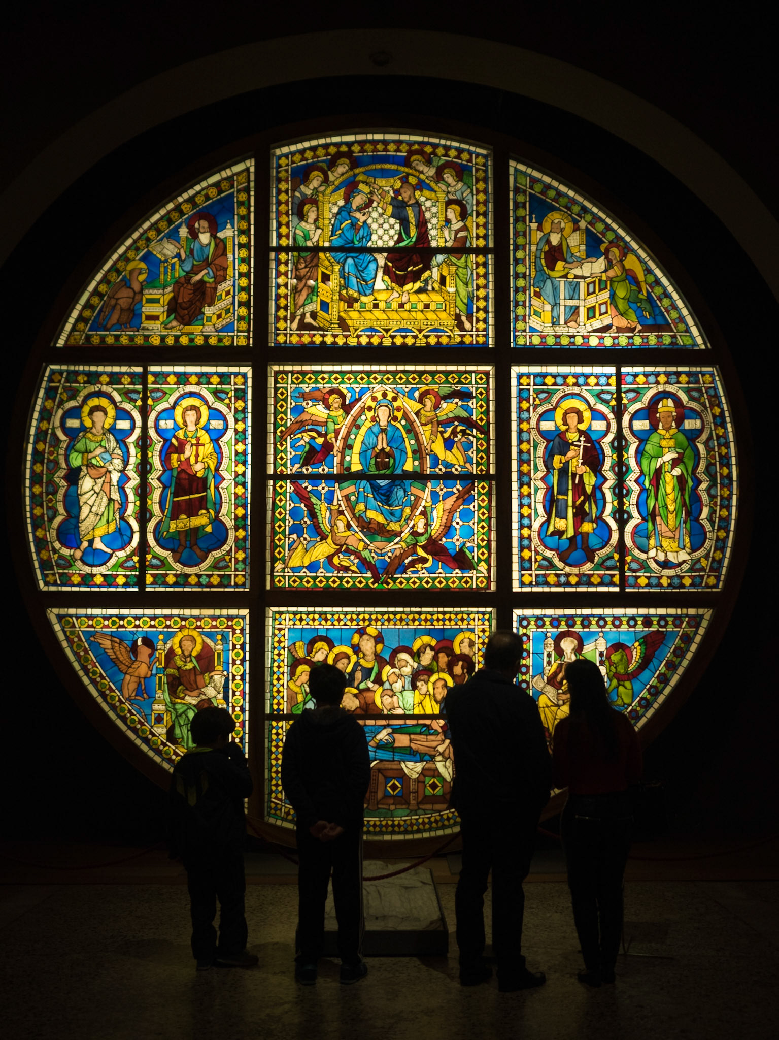 Visitors silhouette by a stained glass work in Museo dell'Opera Metropolitana del Duomo, Siena