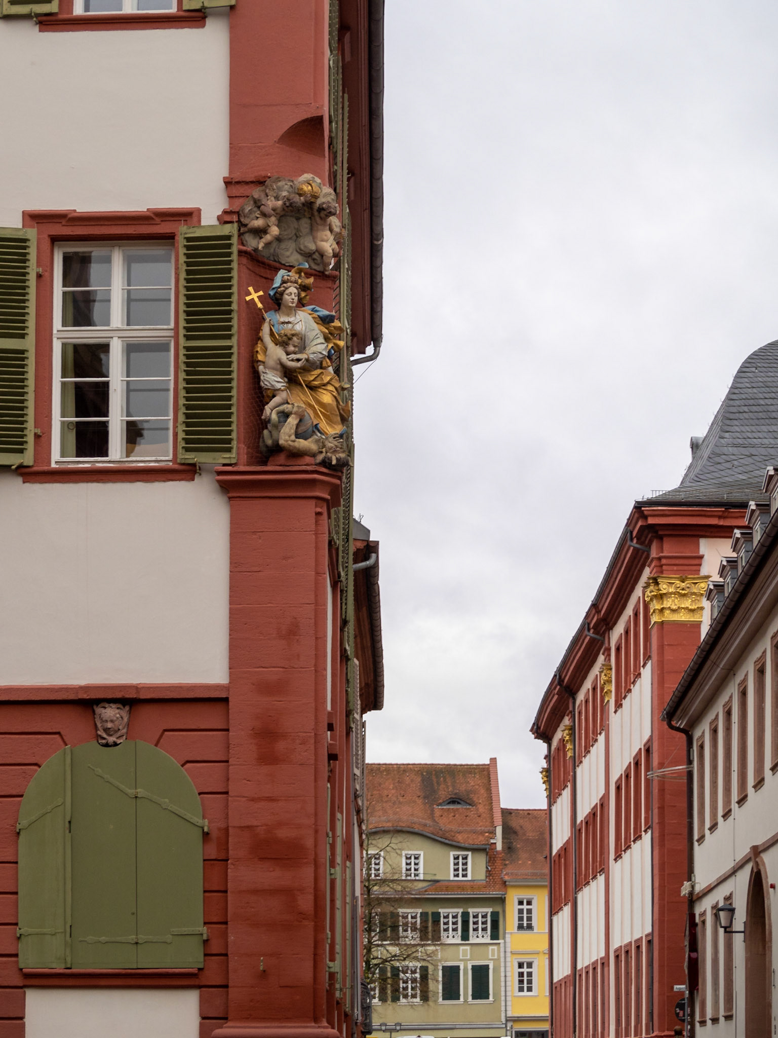 Religious sculpture in a building corner, downtown Heidelberg