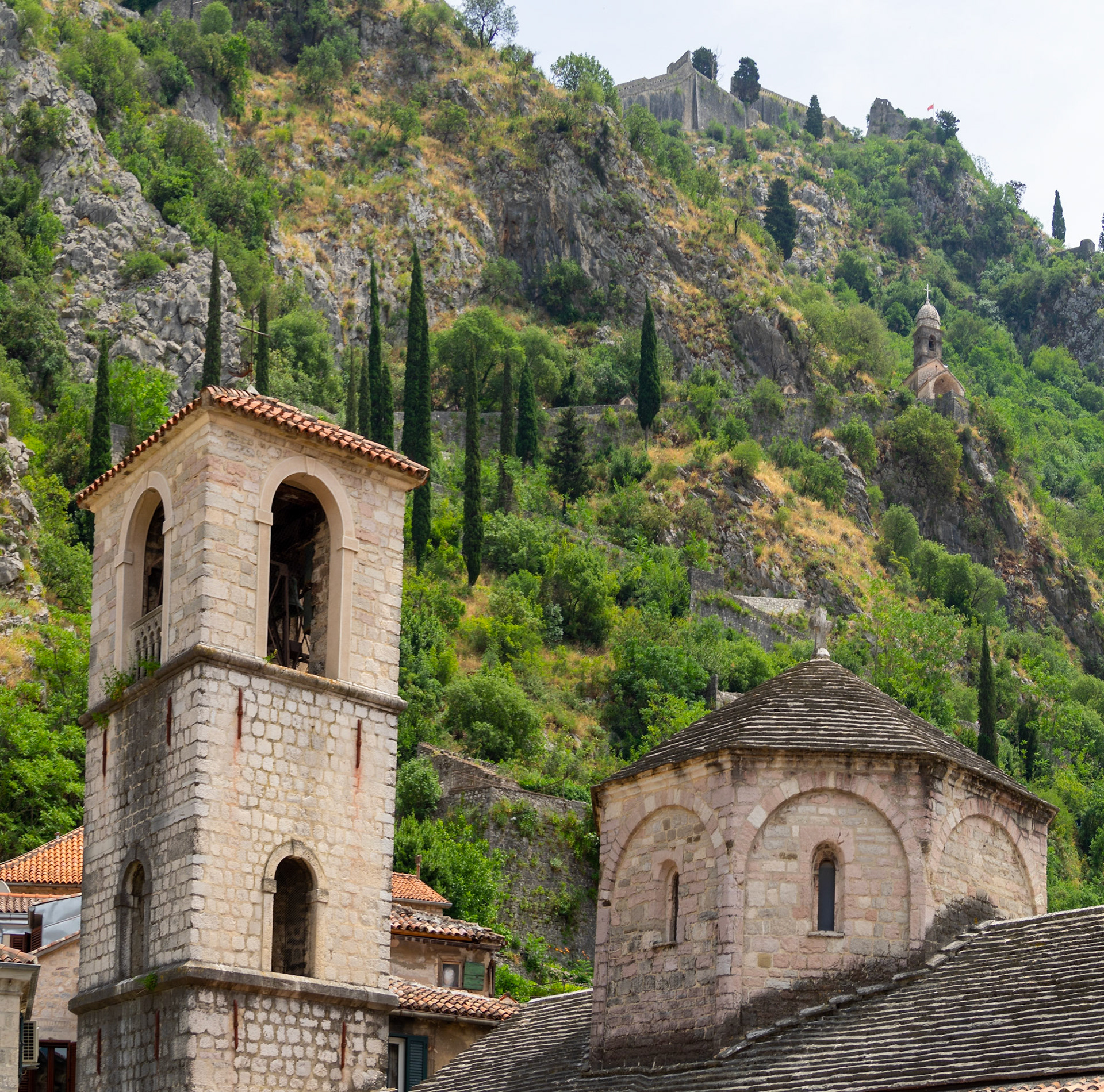 Church of St. Mary Collegiate dome and bell tower bellow the Church of Our Lady of Remedy up in the mountain above Kotor