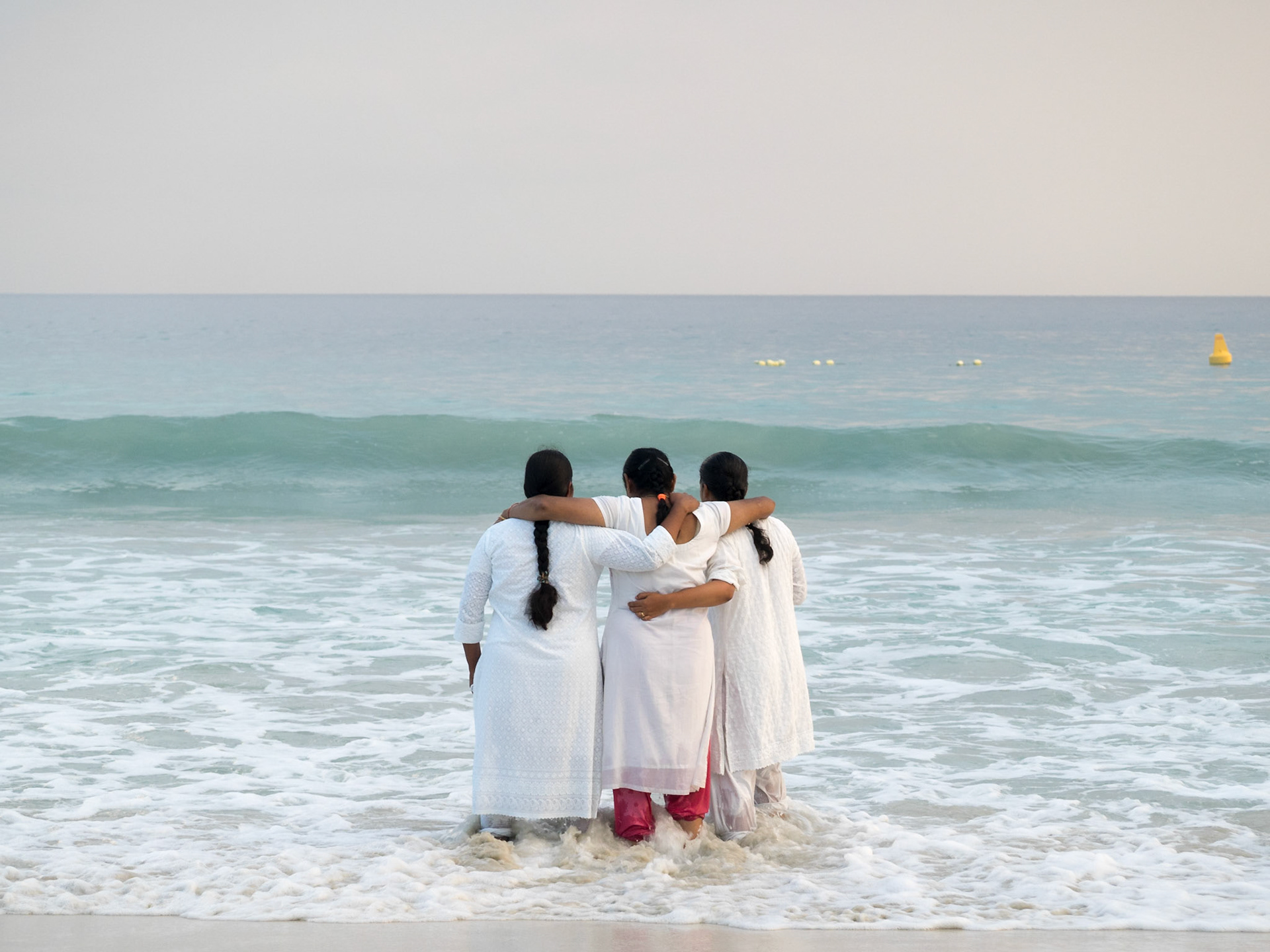 Three Indian women enter the sea at Radhanagar beach, Havelock