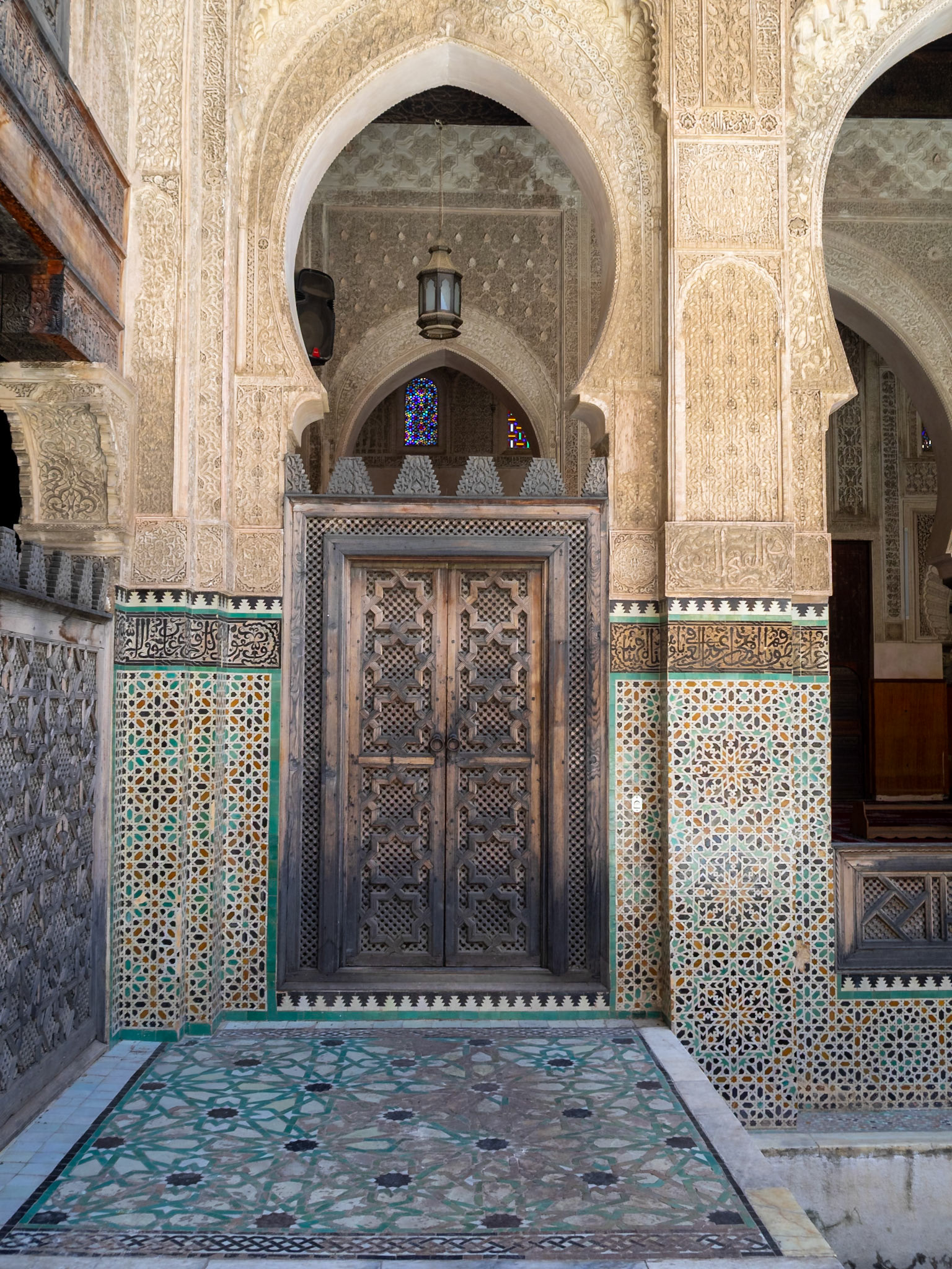 Bou Inania Madrasa courtyard decor with zelij and islamic stucco, Fez, Morocco