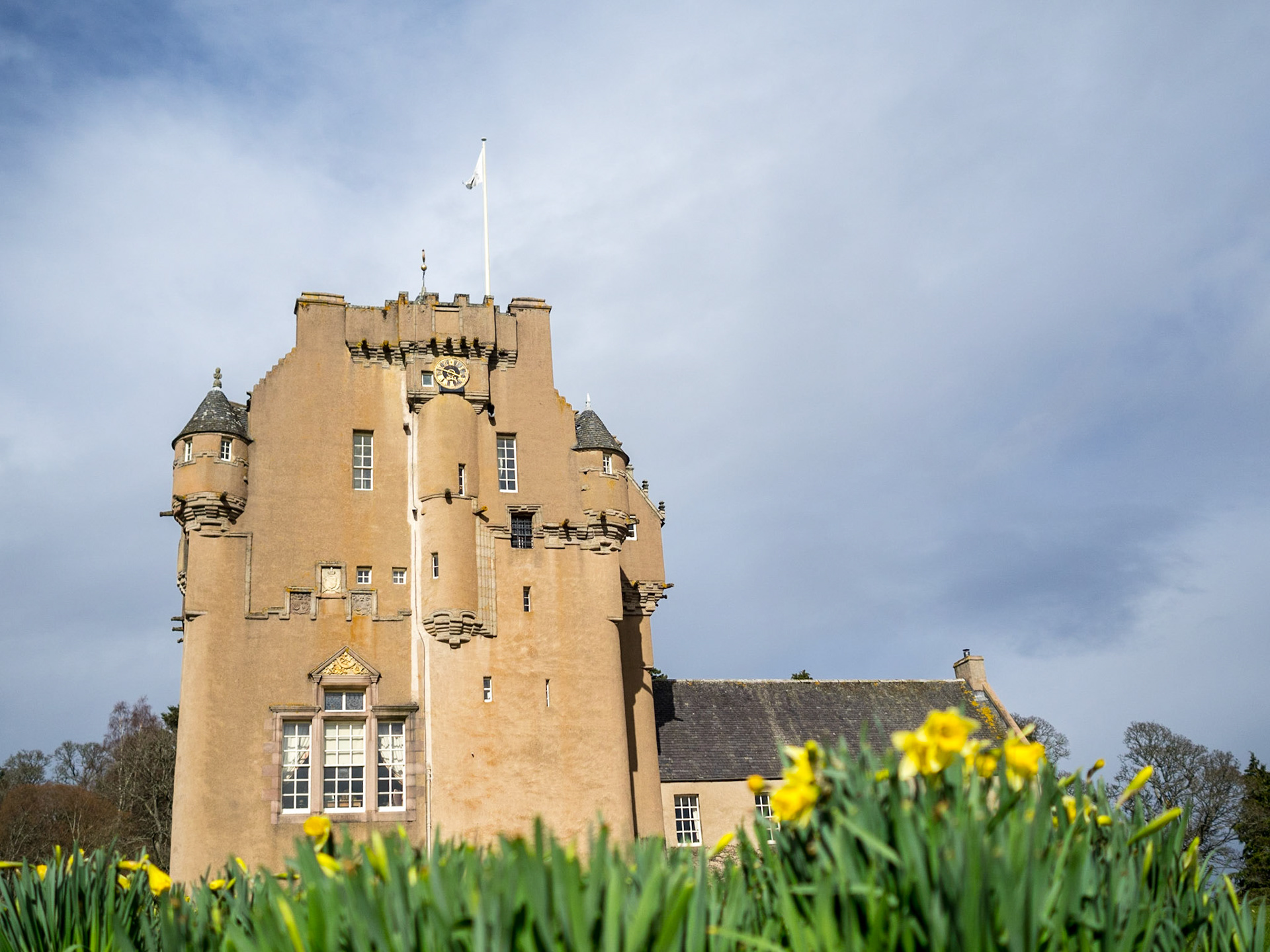 Crathes Castle with yellow flowers