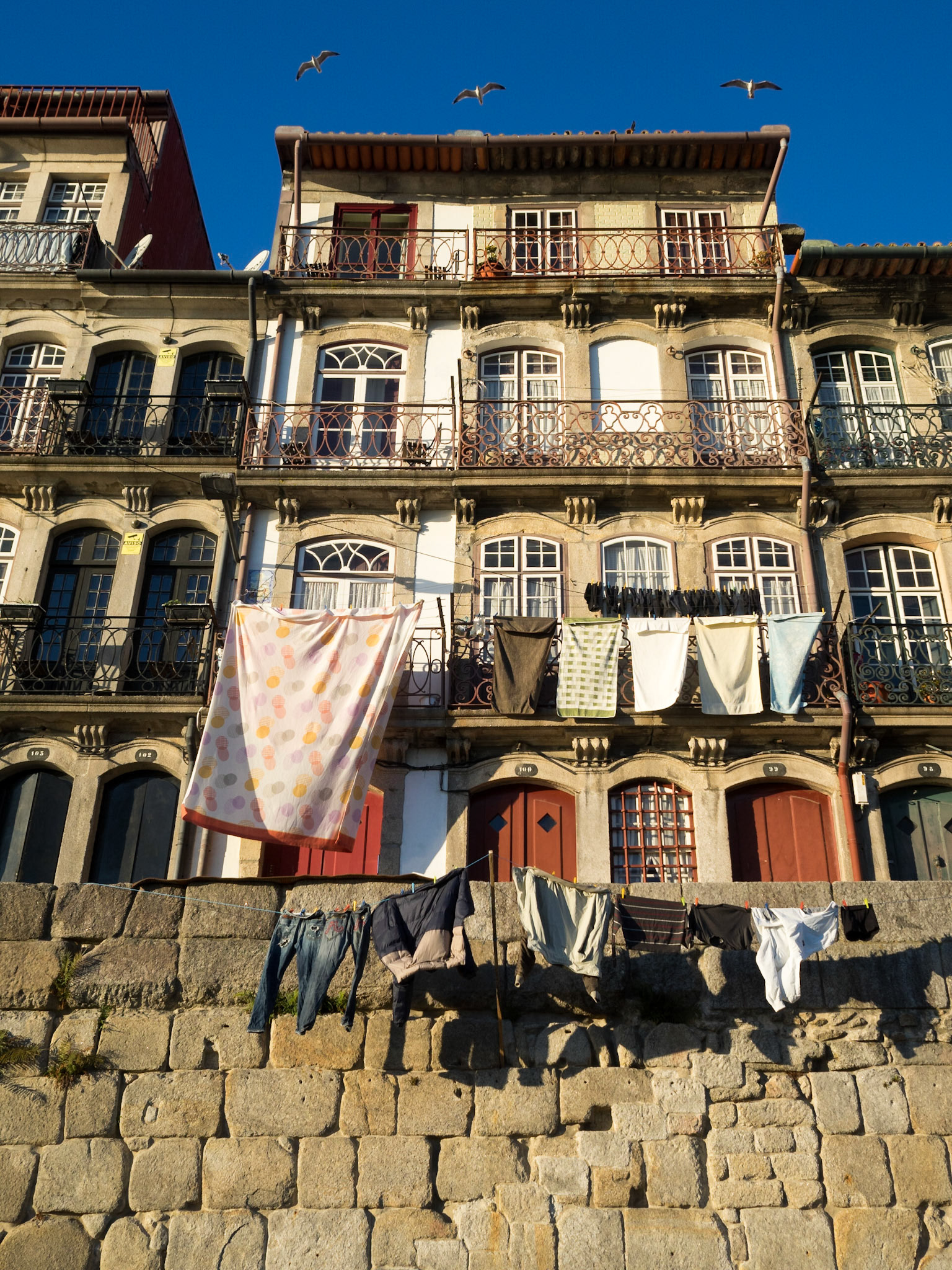 Cloths hanging to dry on the windows of Ribeira, Oporto
