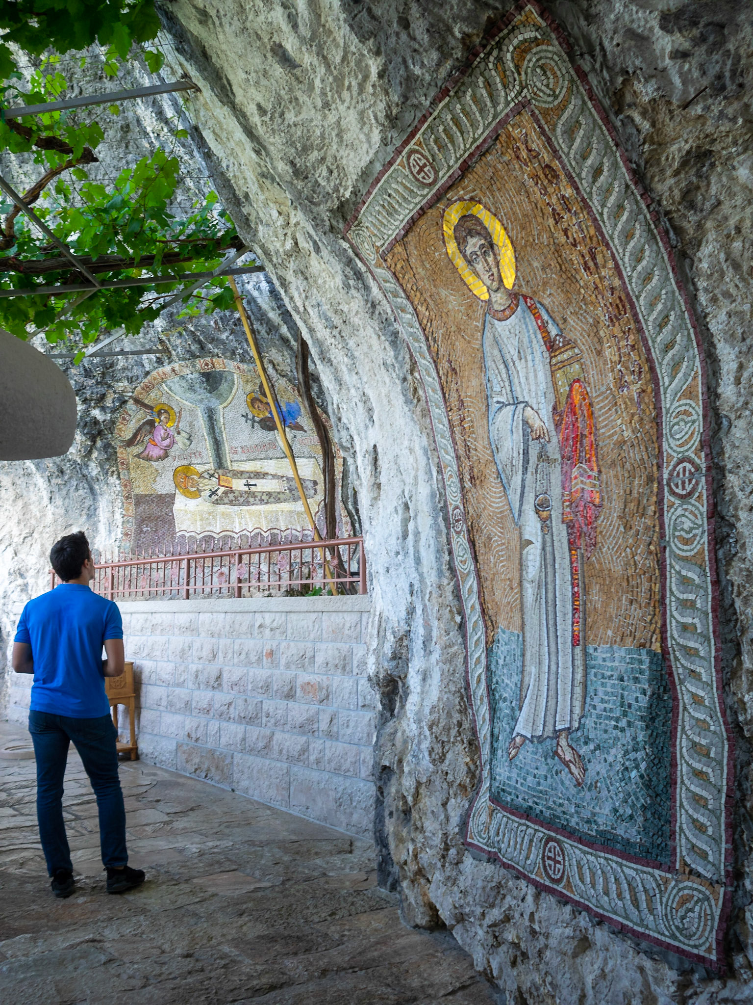 A pilgrim by the Saint Basil of Ostrog mosaic at the Ostrog Monastery