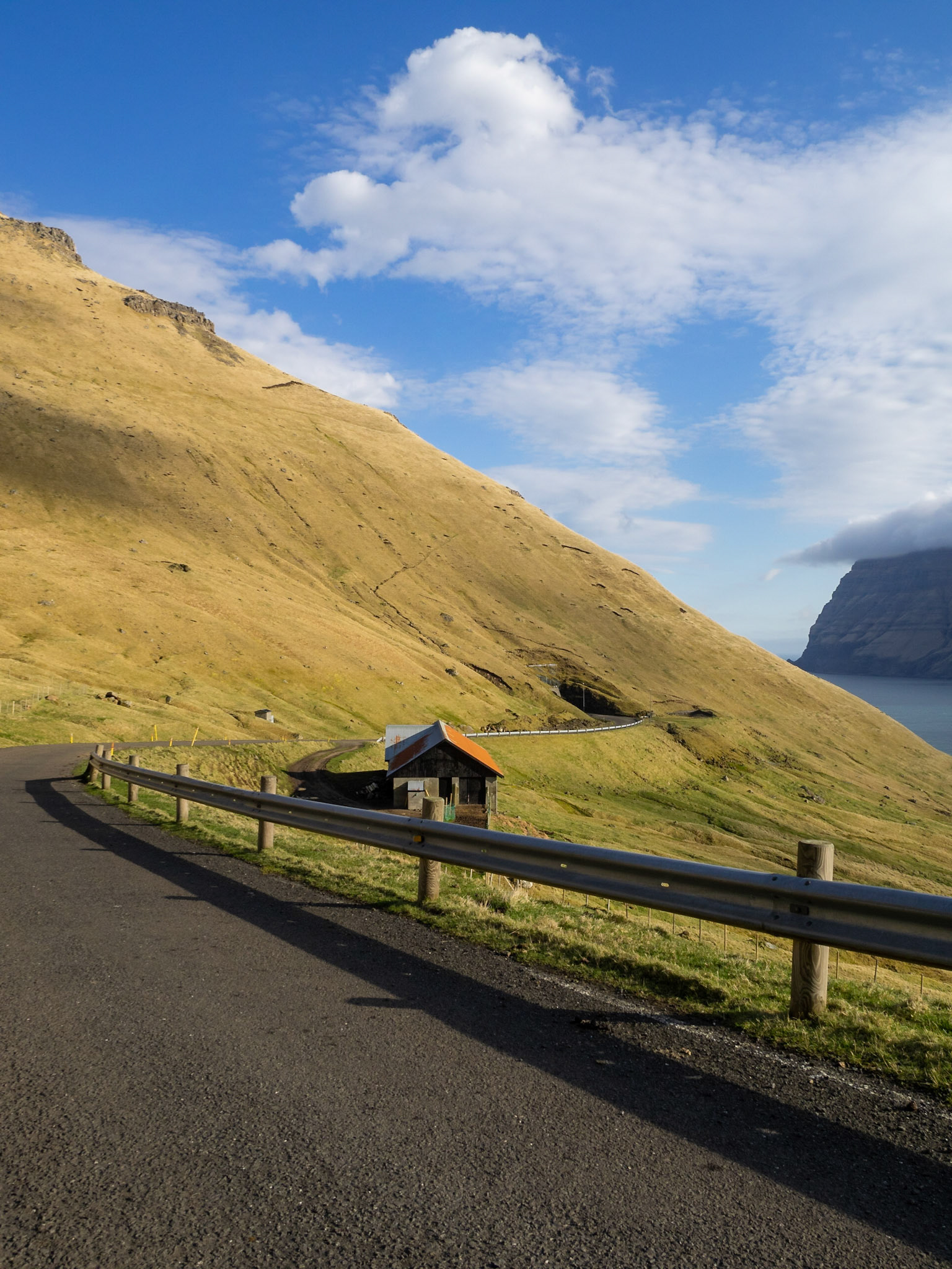 Road and tunnel cutting through the mountain in Kalsoy
