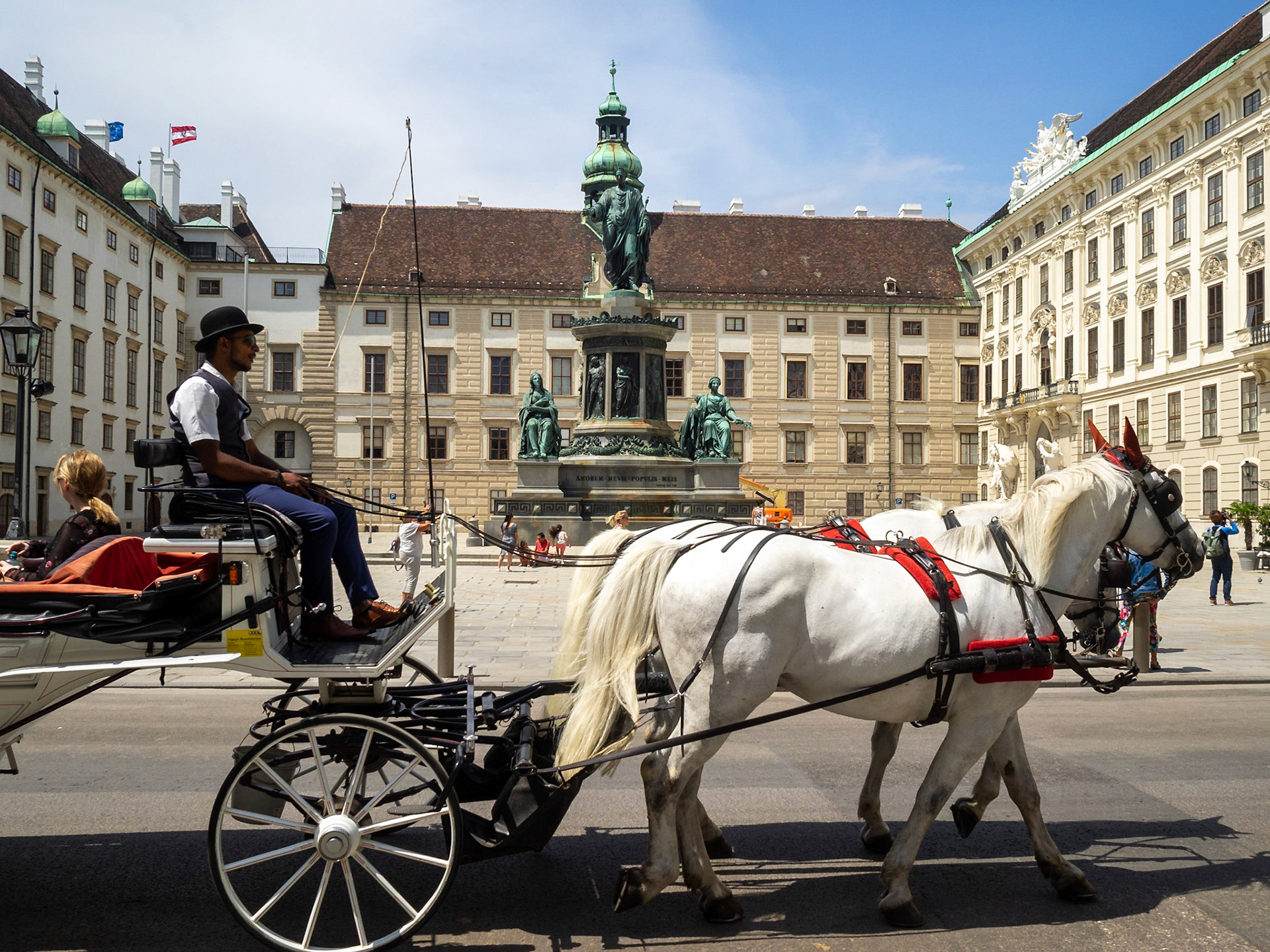 A horse chariot crosses the Hofburg Palace courtyard