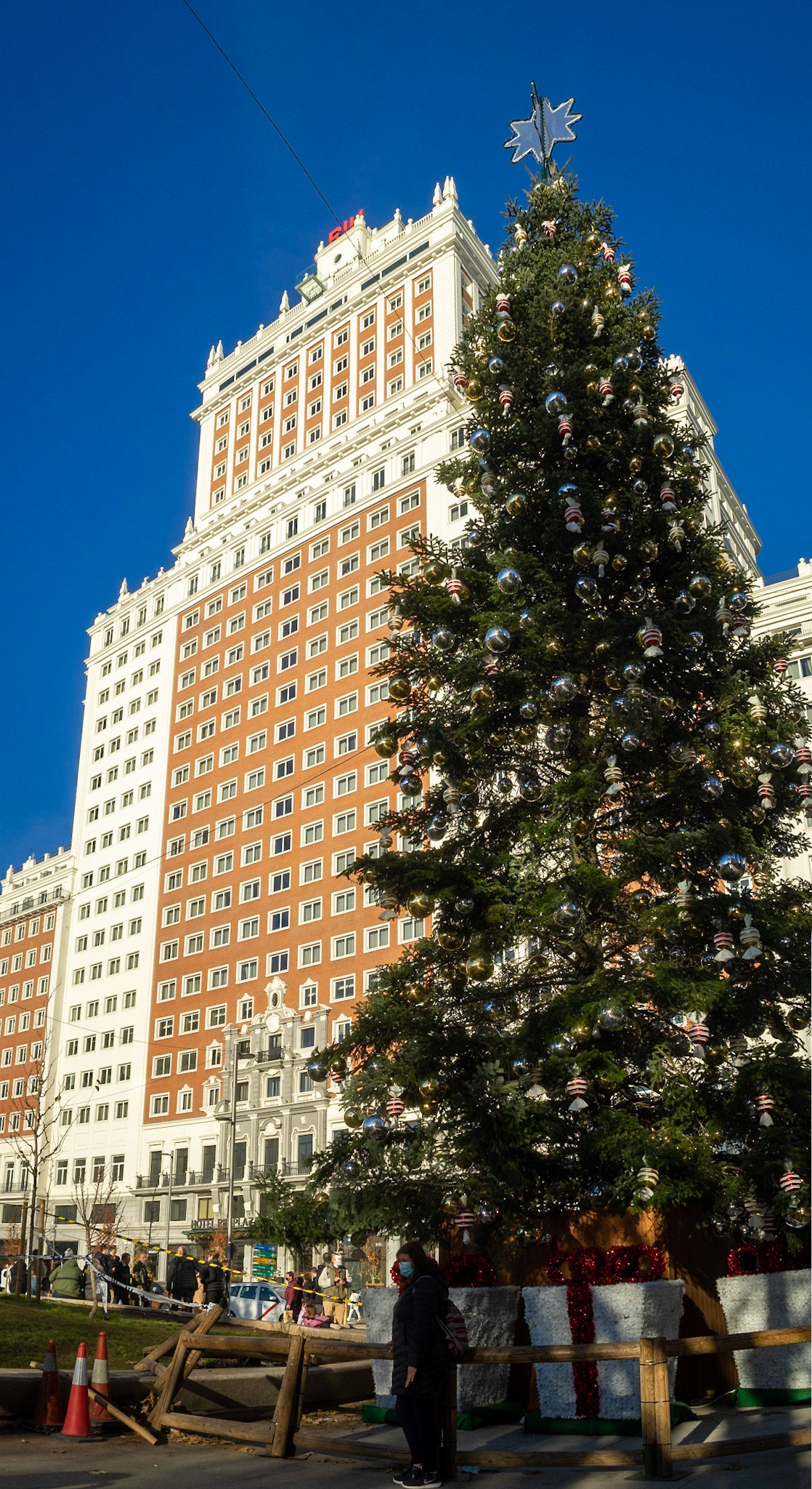 Taking a picture by the big Christmas Tree in Madrid Plaza de España