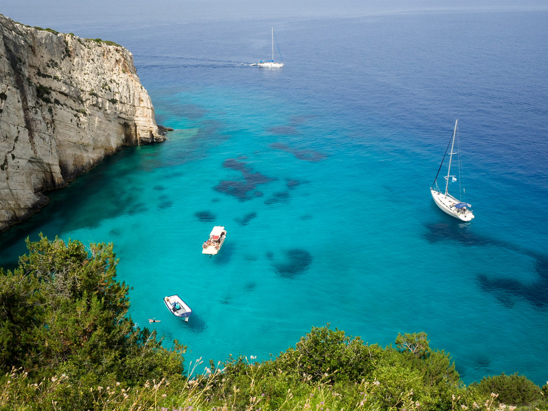 Yacht boats floating over the turquoise waters of Zakynthos island