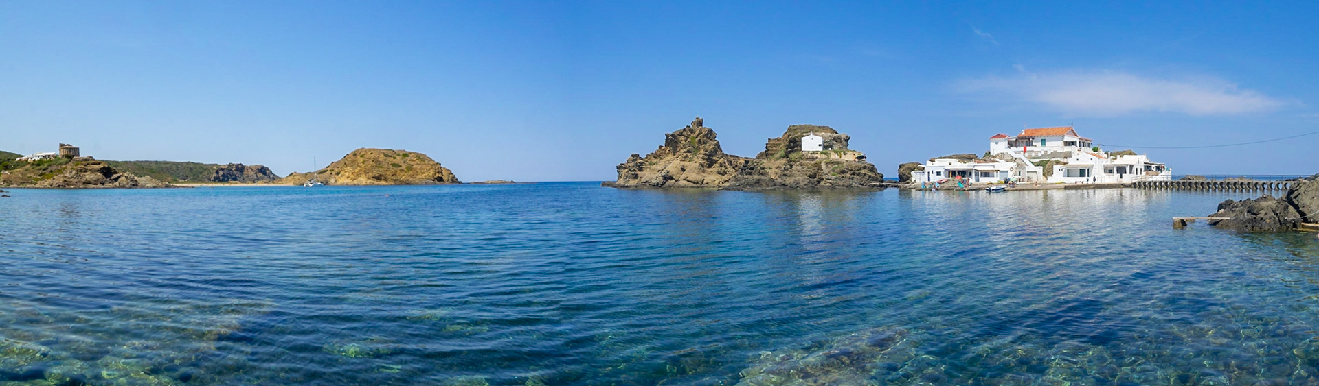 Panoramic view from Cala Sa Mesquida to the village white houses, Menorca