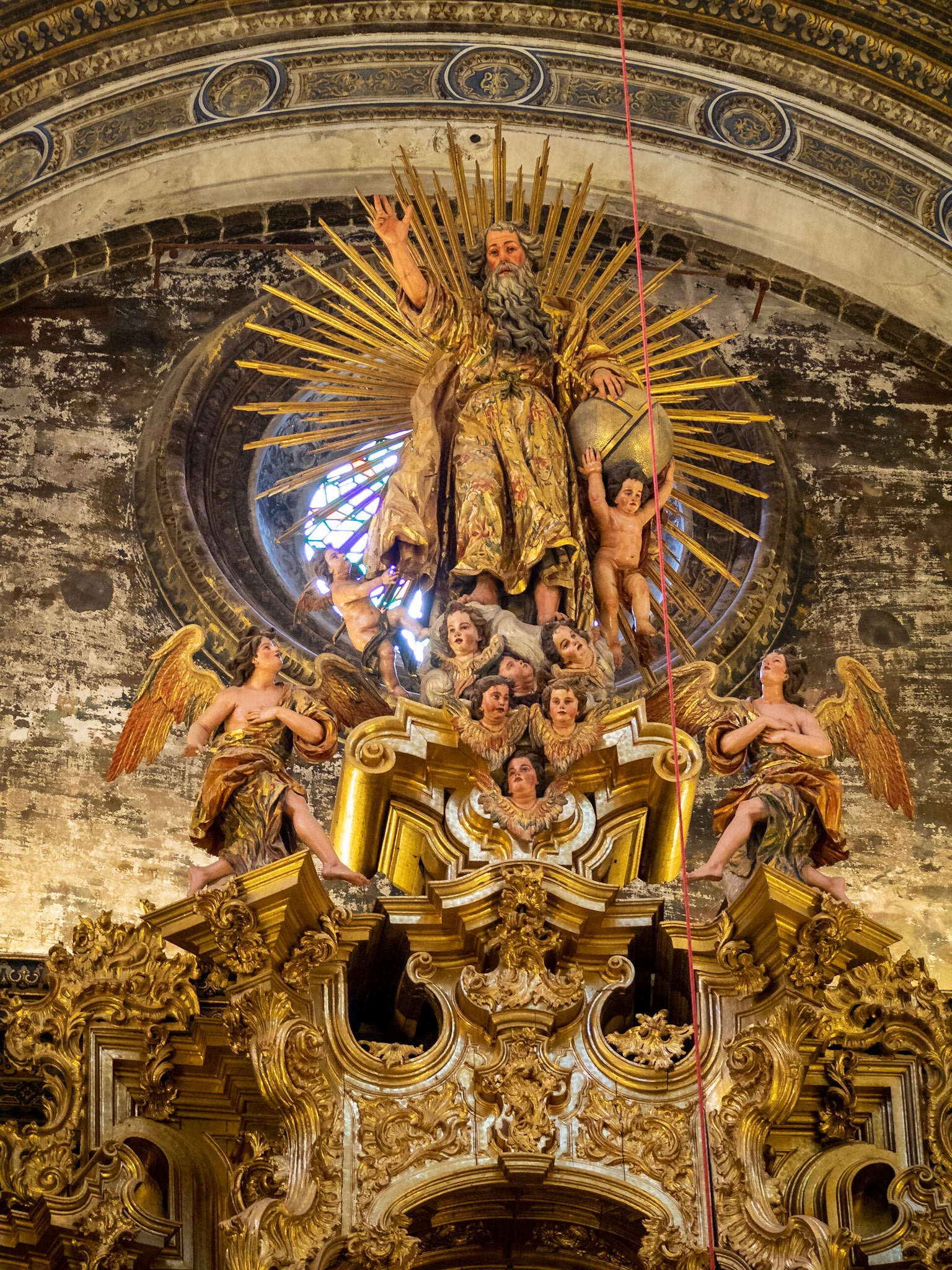 God represented at the top of the high altarpiece at the  Iglesia Colegial del Divino Salvador, Seville